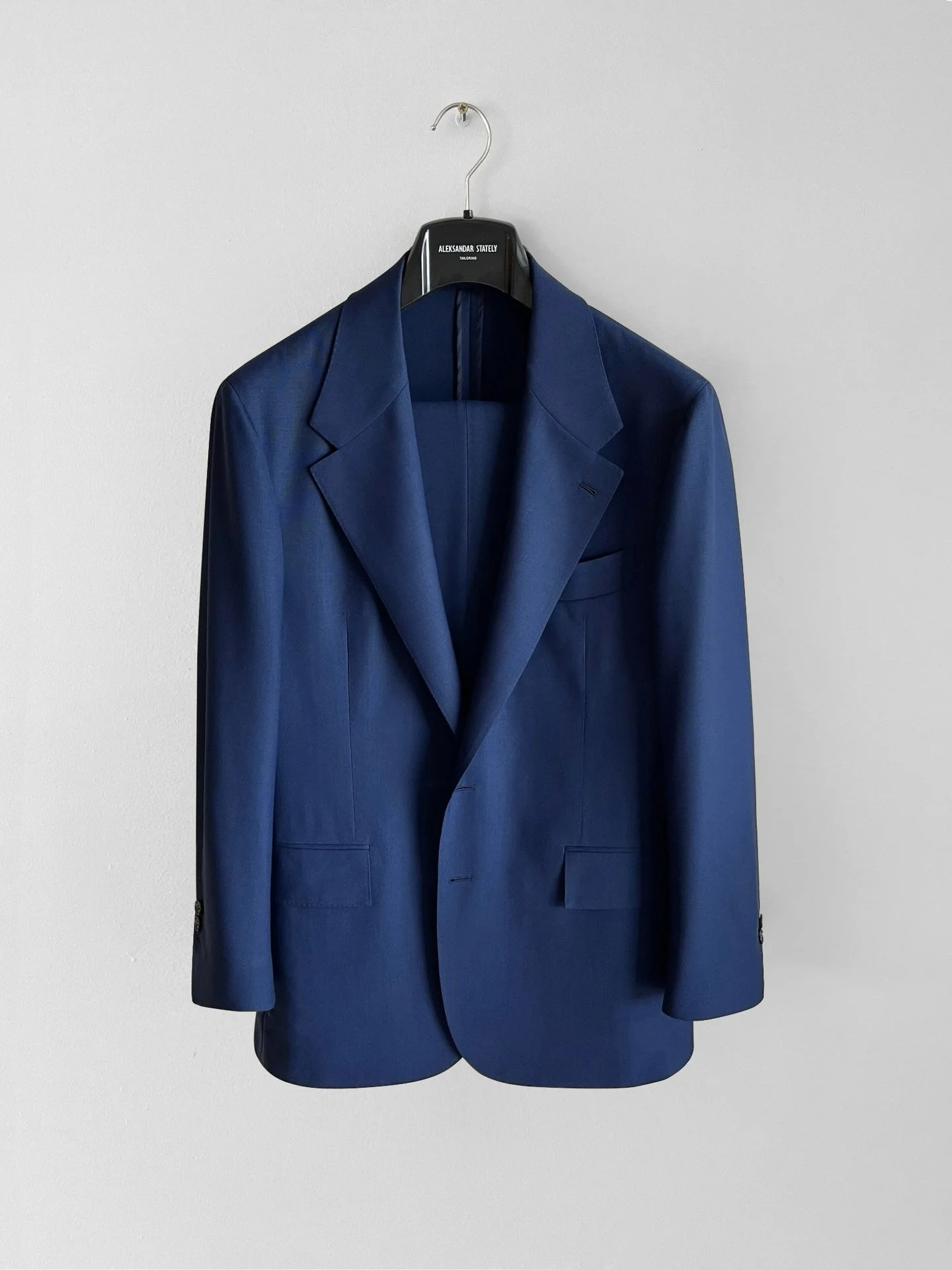 A made-to-measure navy blue jacket crafted from lightweight fresco wool with stretch. Unlined with a soft structure for breathable comfort in warm conditions.