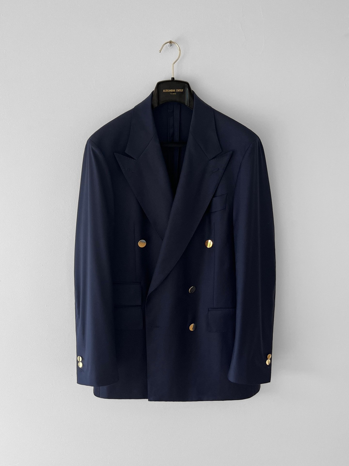 Timeless navy, cut double-breasted and made to measure. Signature peak lapels, finished with elegant gold buttons.