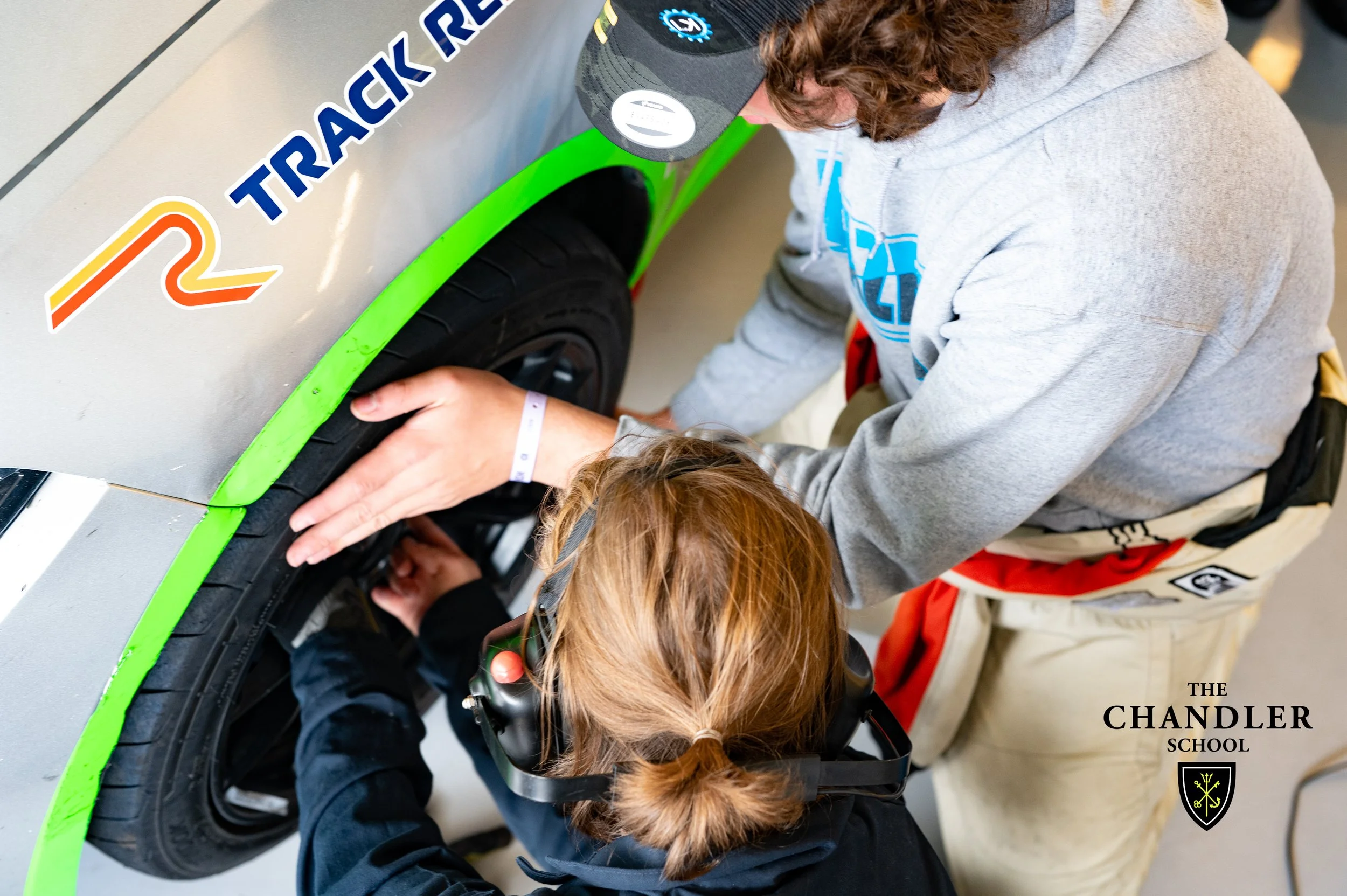 Alumni Pit Crew teaching the younger students