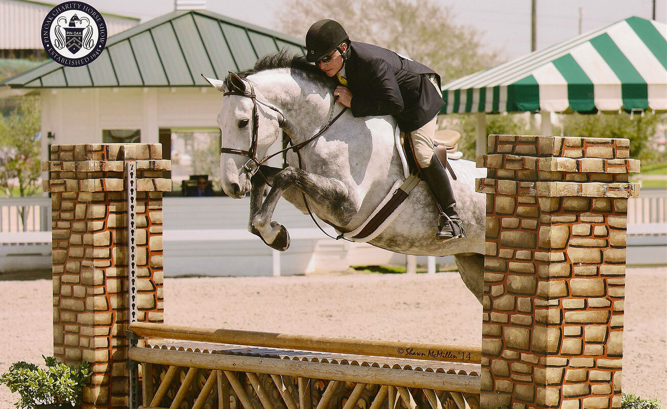 home-Bill-jumping-unbraided-gray-horse.jpg