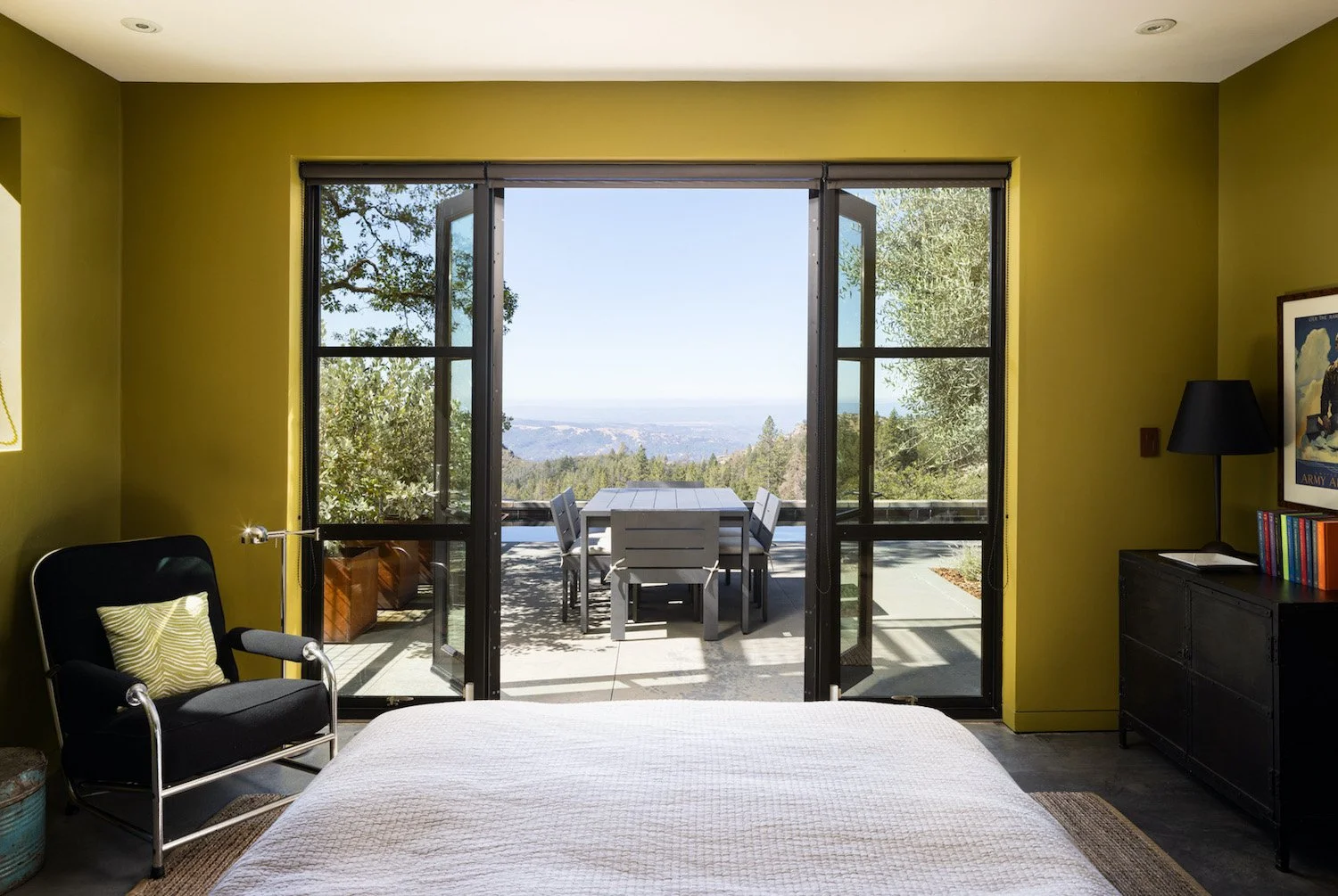Bedside views captured in stunning bedroom photography. Lime green color walls and open glass doors to outdoor breathtaking views of Calistoga showing off best of west coast living.