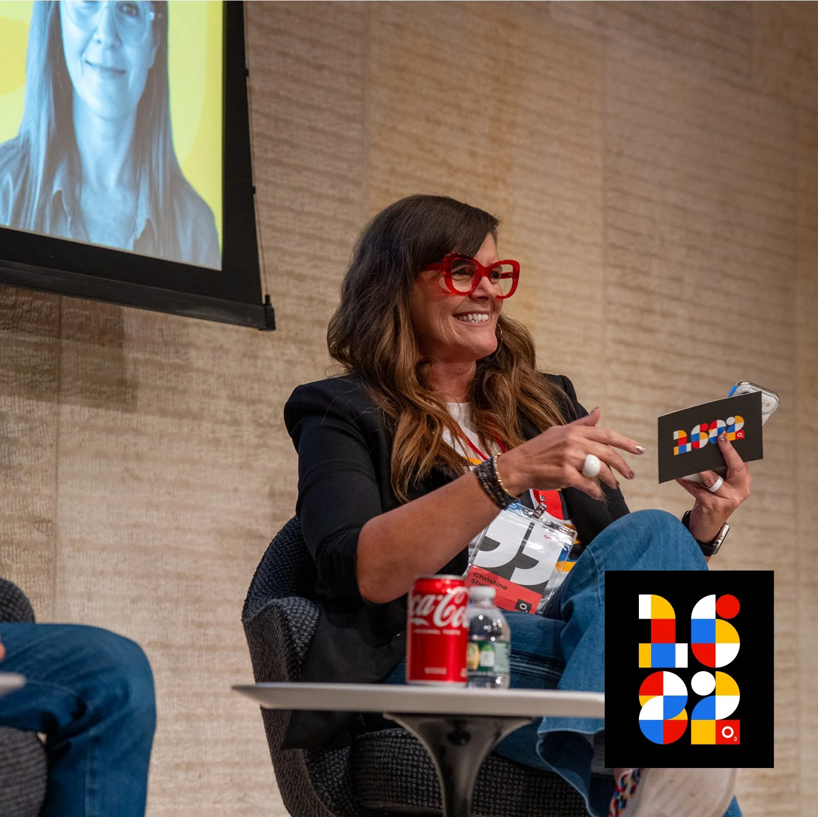 Christine smiling while leading a panel conversation at the 1682 conference
