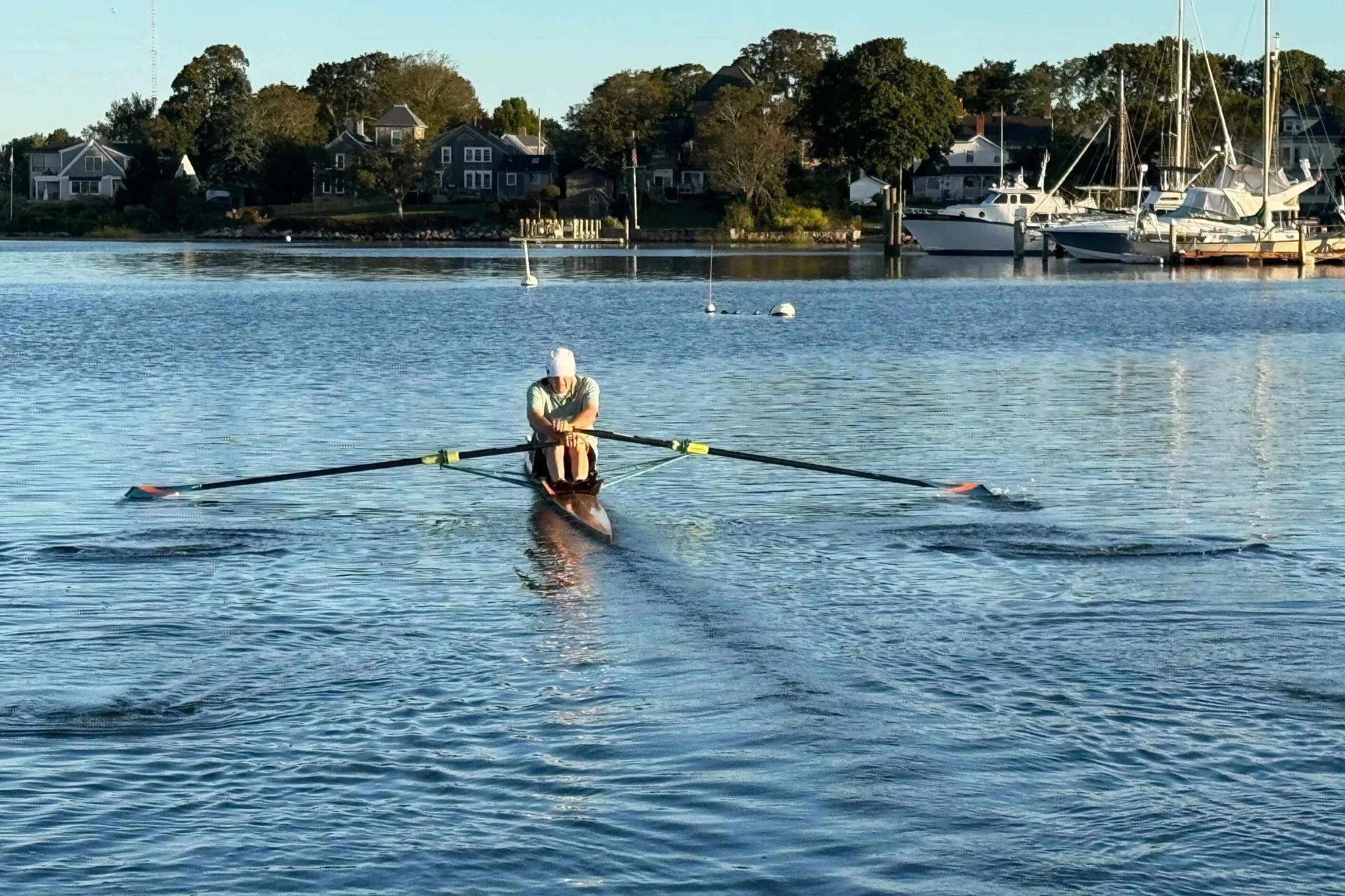 D'Arcy MacMahon, at 86 years old, in training for the 2025 HOCR, rowing the same wooden 1x he rowed at the first HOCR in 1965.