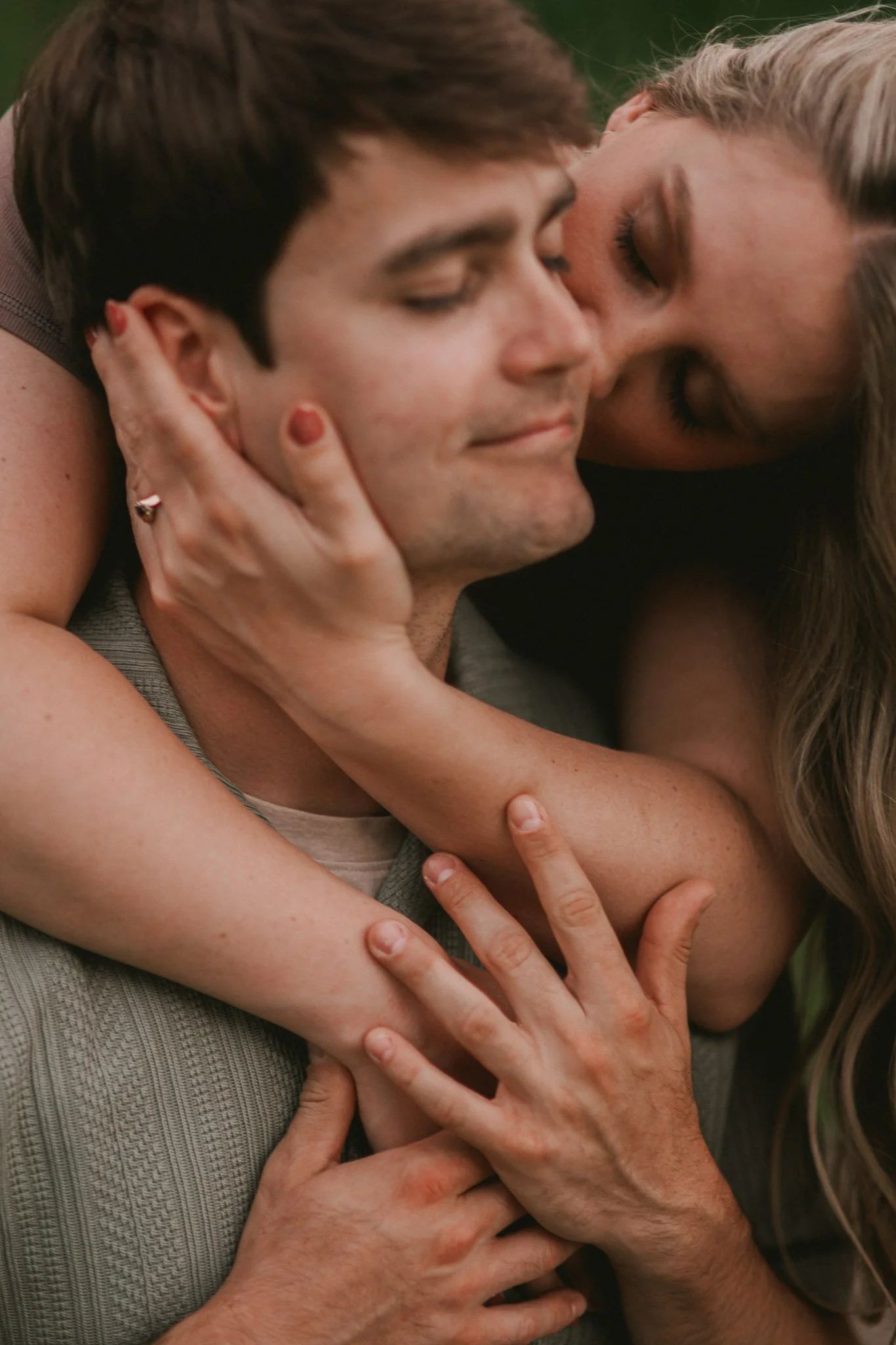 engaged couple embrace in a romantic portrait in tower grove park saint louis missouri Photographed by Julia Spencer of Jewels Photo Co.