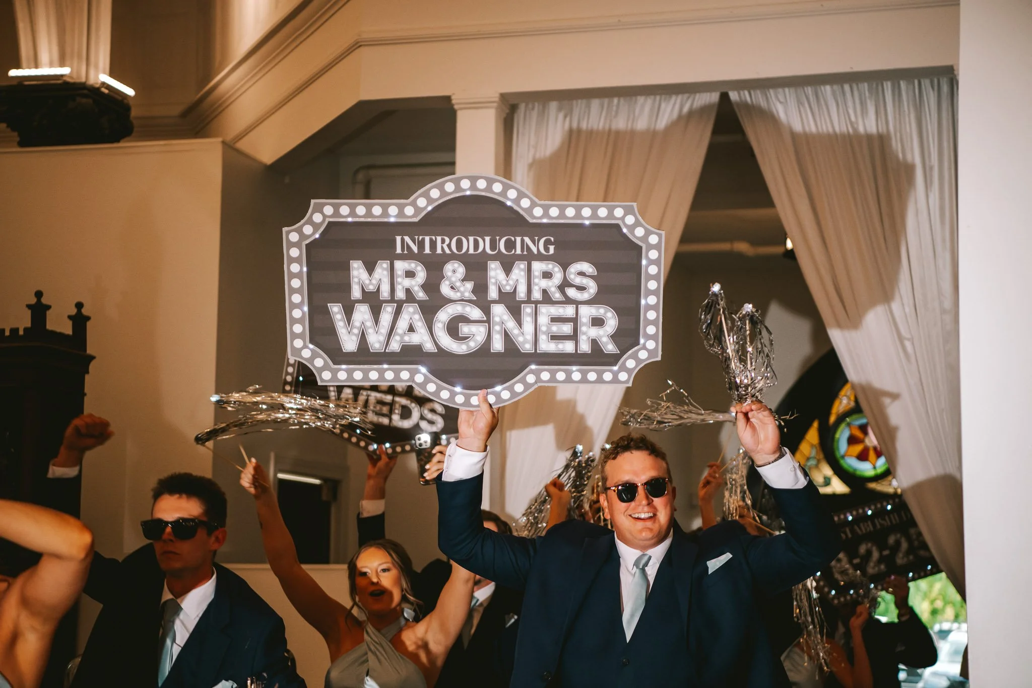 The wedding party grand entrance with signs from DJ Cole Coleman at Main Street Abbey in Columbia, Illinois