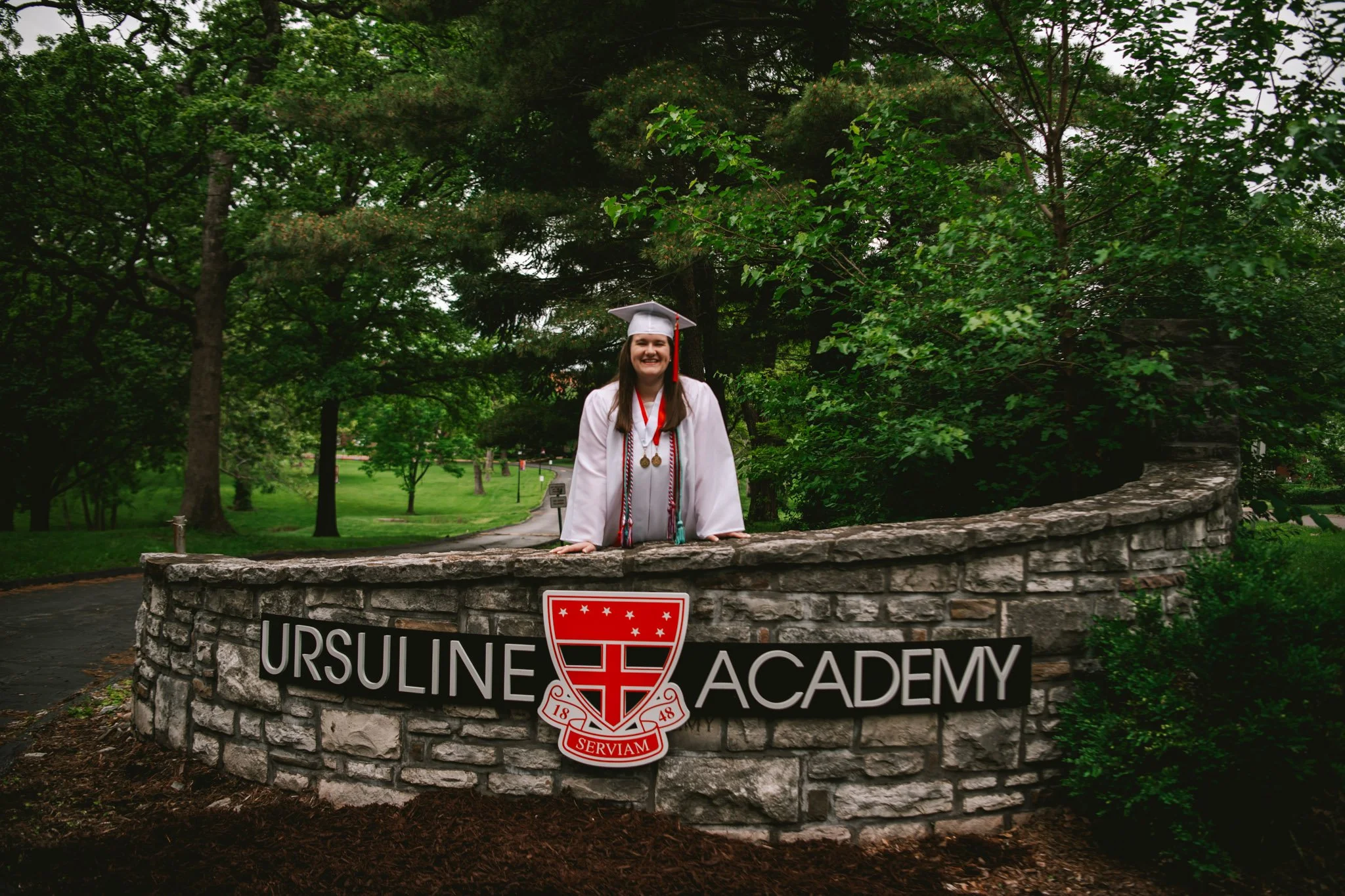senior portrait at graduation of Ursuline Academy Sign