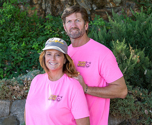   Julie O’Loughlin and a man in Tsasdi Resort t-shirts  