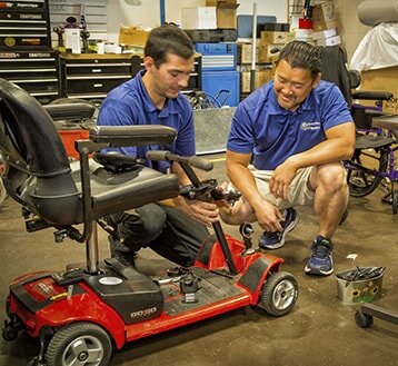  Two men inspecting a mobility device 