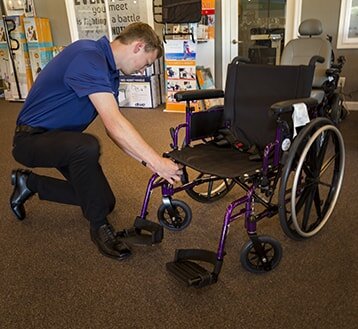  Man inspecting a wheelchair 