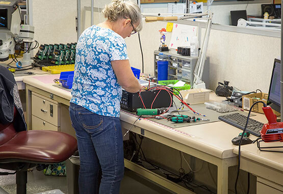  Woman fixing a machine. 