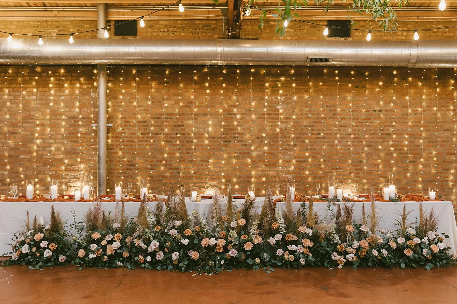 Florals and candles on the head table