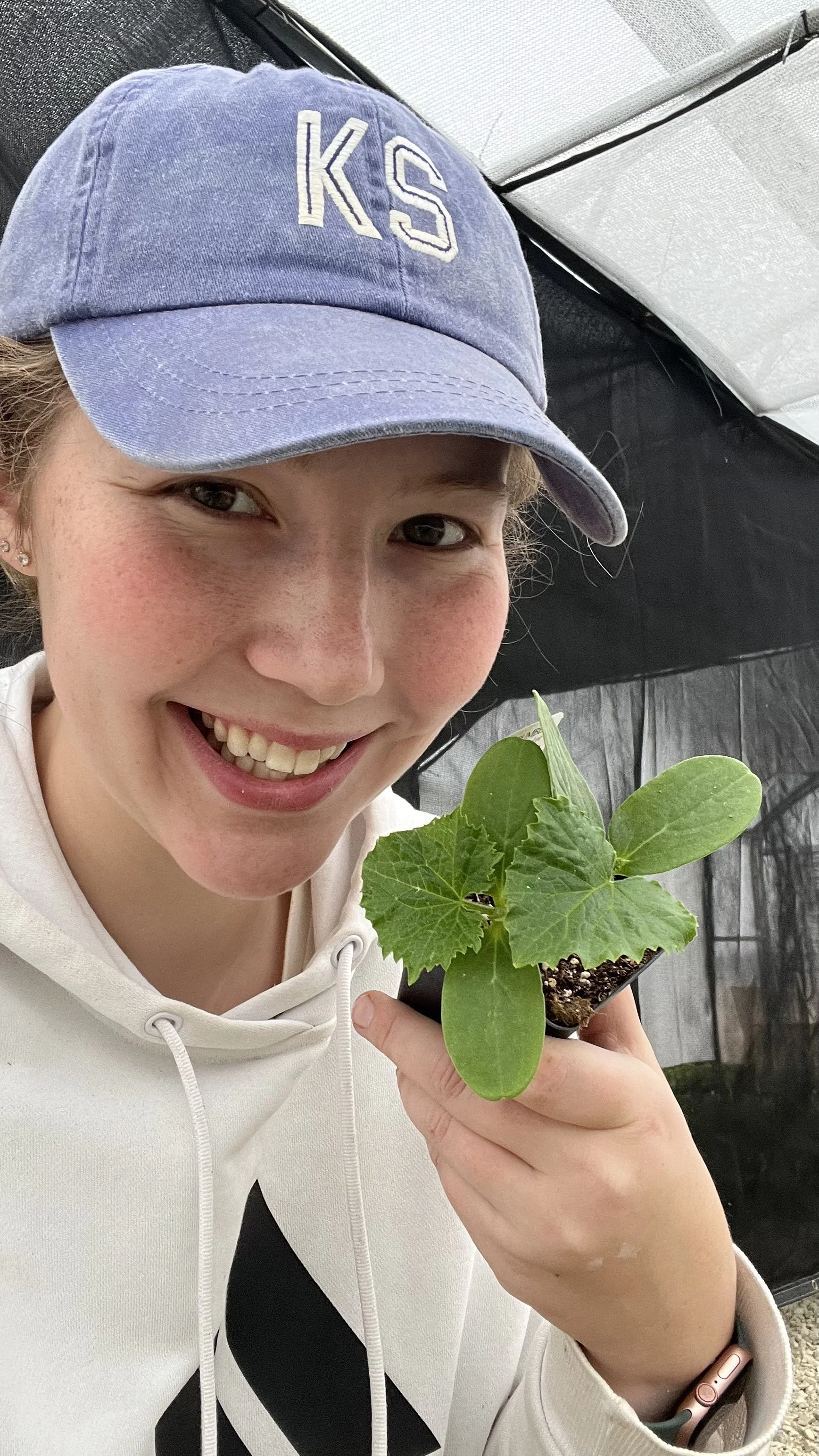 Renata with a cucumber plant
