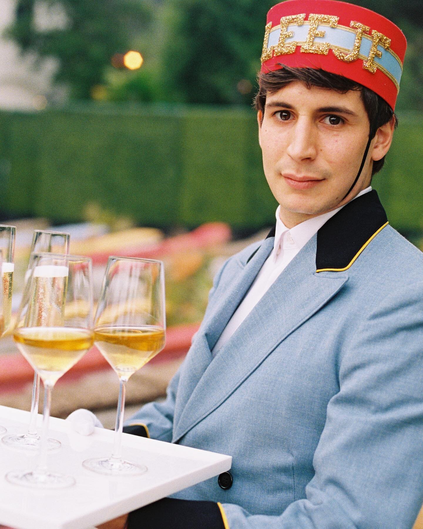 LEEJF Boy reporting for duty. Corrado wears a true vintage 1930s bellmen outfit to drive the couple&rsquo;s getaway car and serve champagne. For this Hollywood wedding, we created a custom hat with deadstock fabric as inspired by a Wes Anderson chara