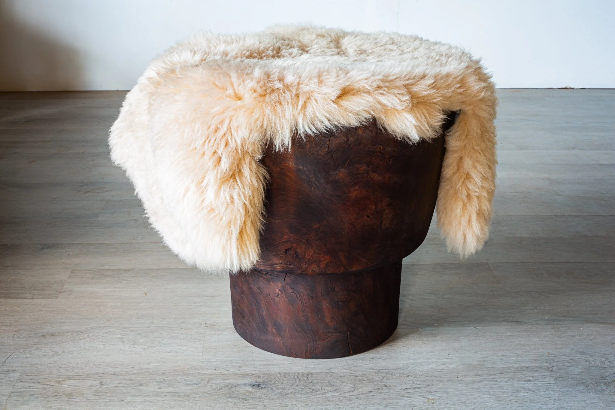 Fumed cherry stool with shearling throw