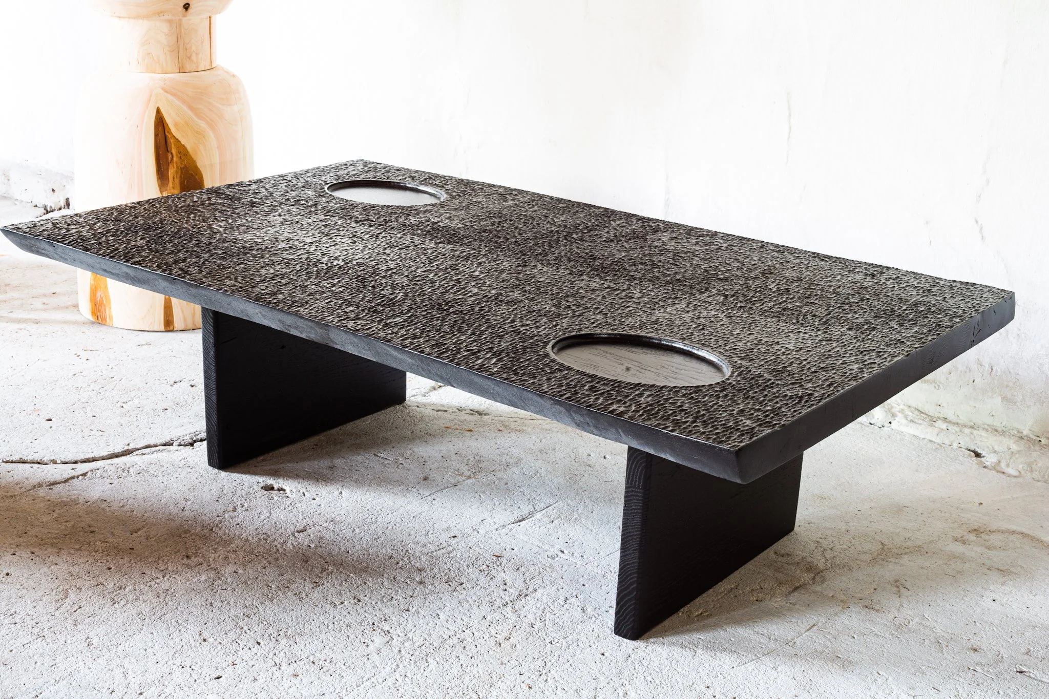 Ebonized coffee table with carved texture and inset bowls