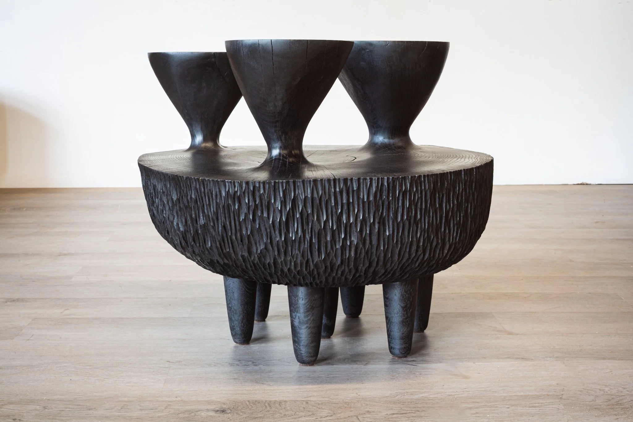 Ebonized white oak side table with three heads