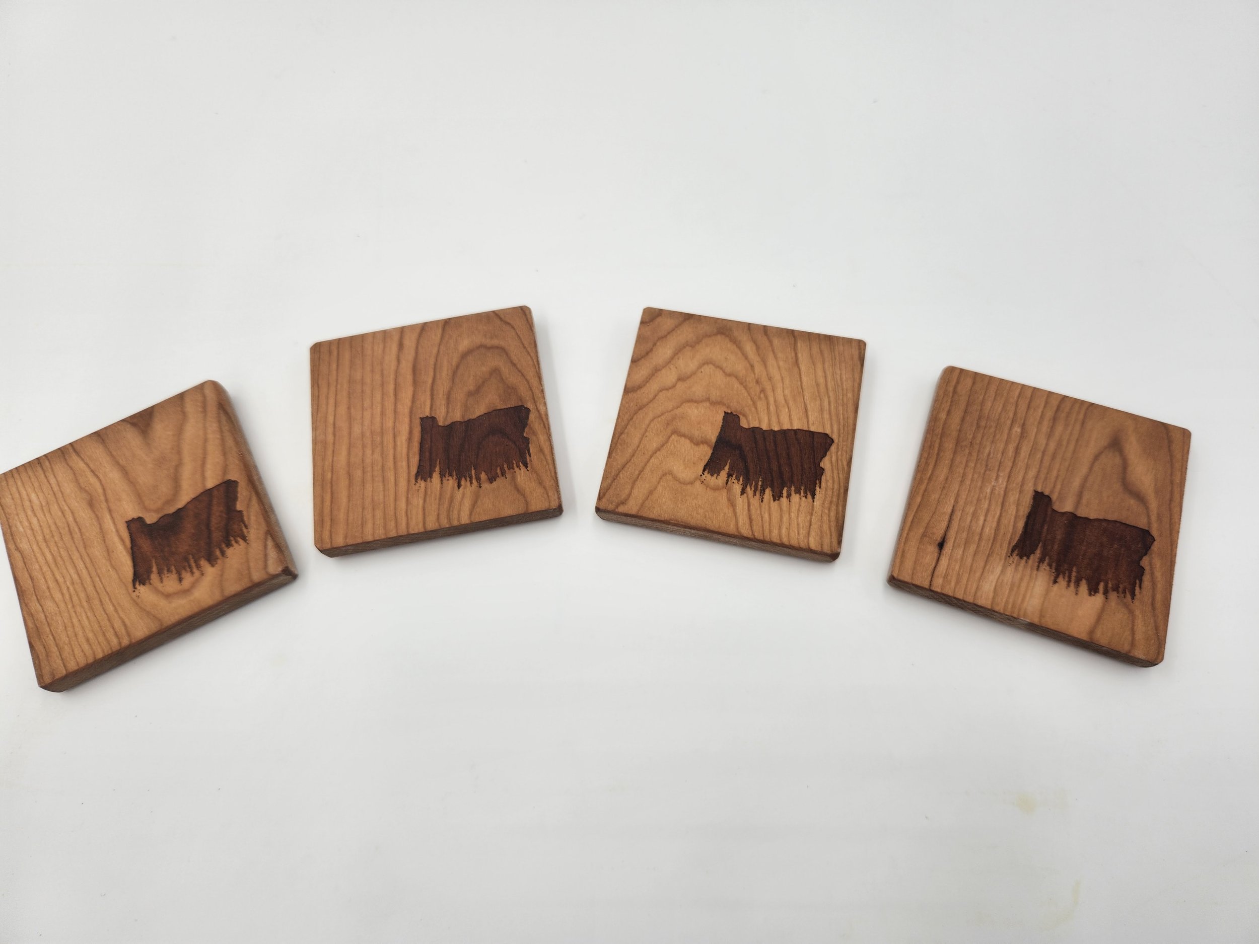 Set of four Cherry coasters with Oregon Trees outline laser-etched on each.