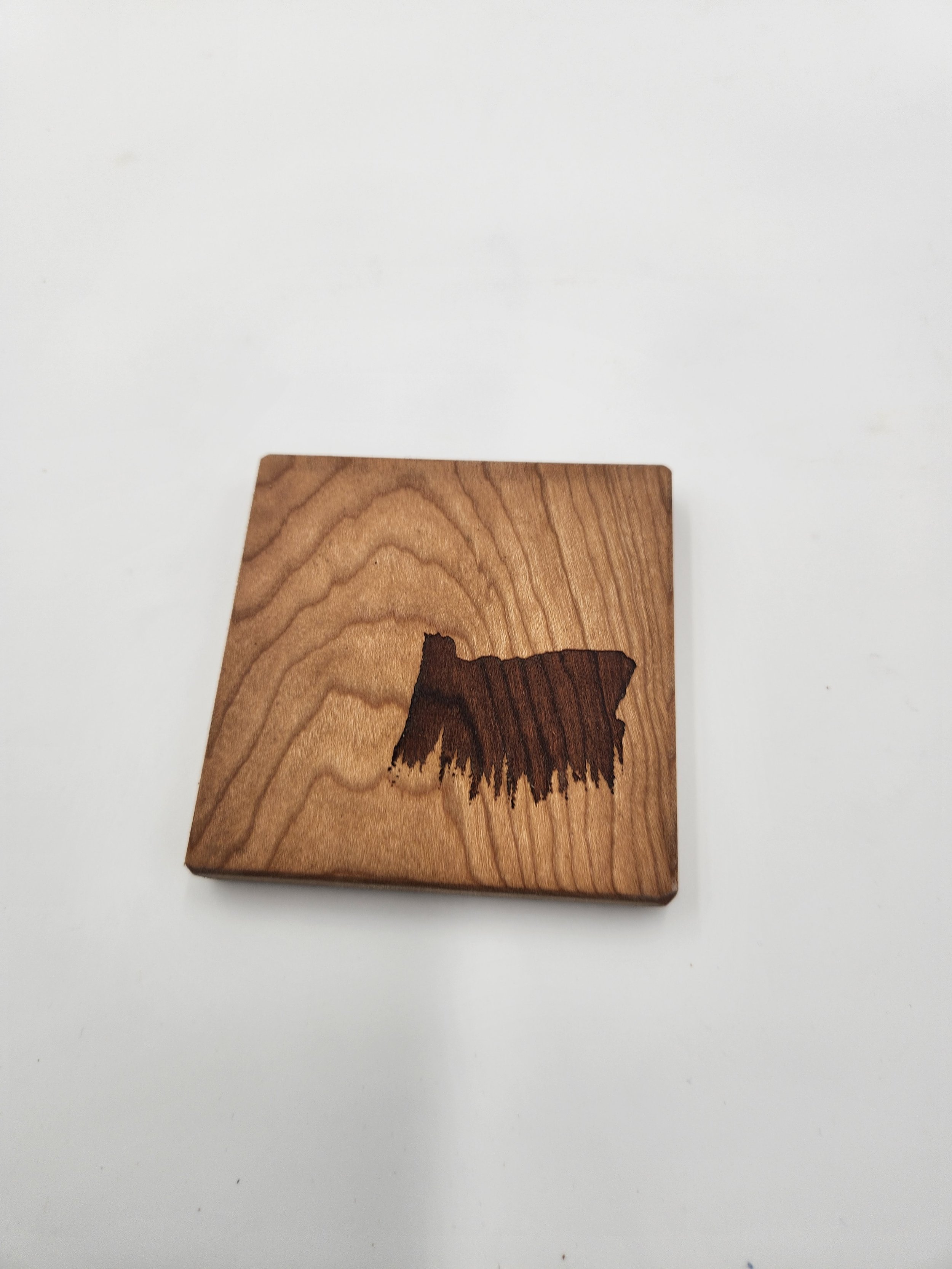 Single Cherry coasters with Oregon Trees outline laser-etched on it.