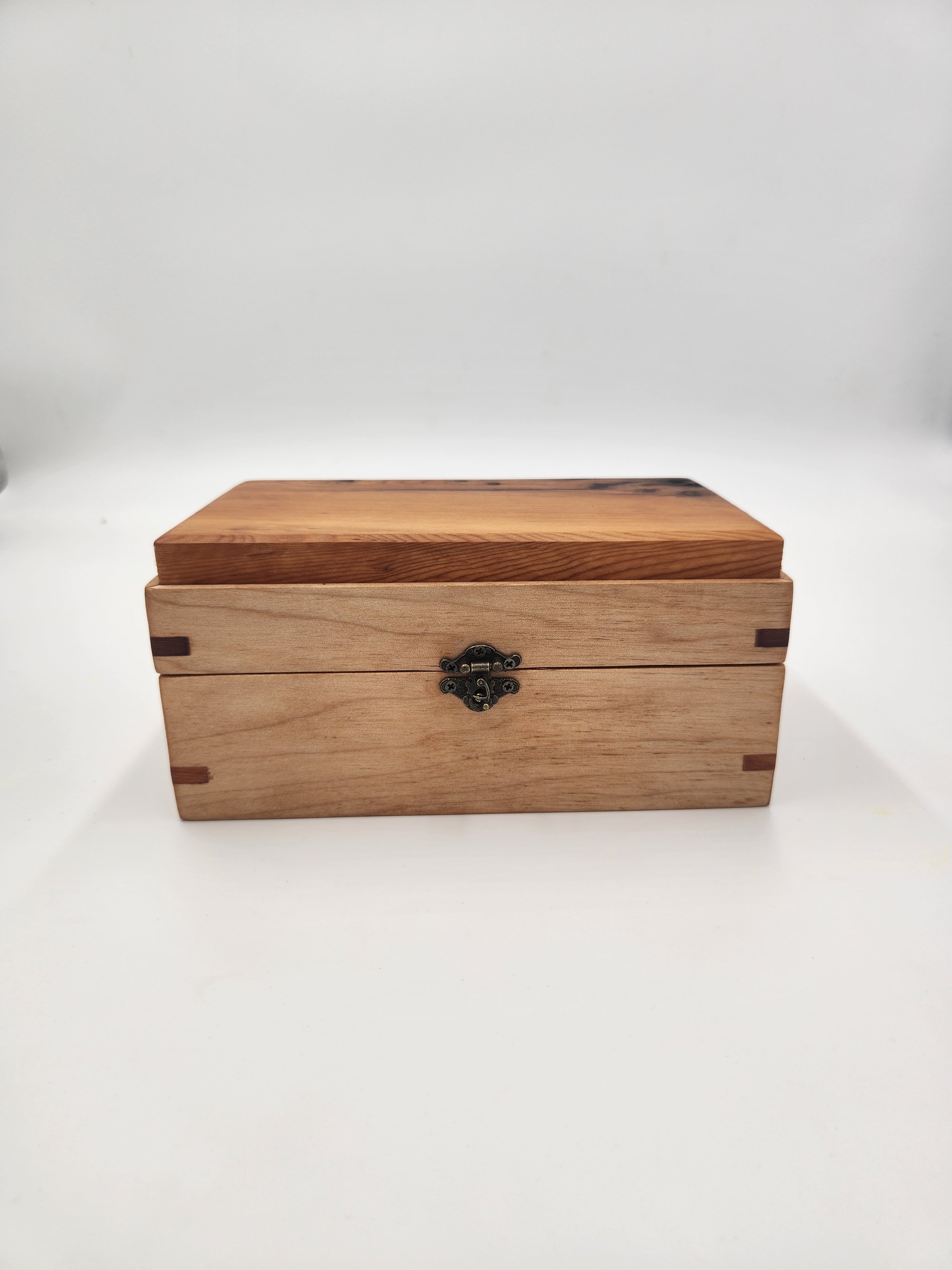 Decorative mitered box with brass latch and hinges, in Big Leaf Maple, with a Pacific Yew inset lid.