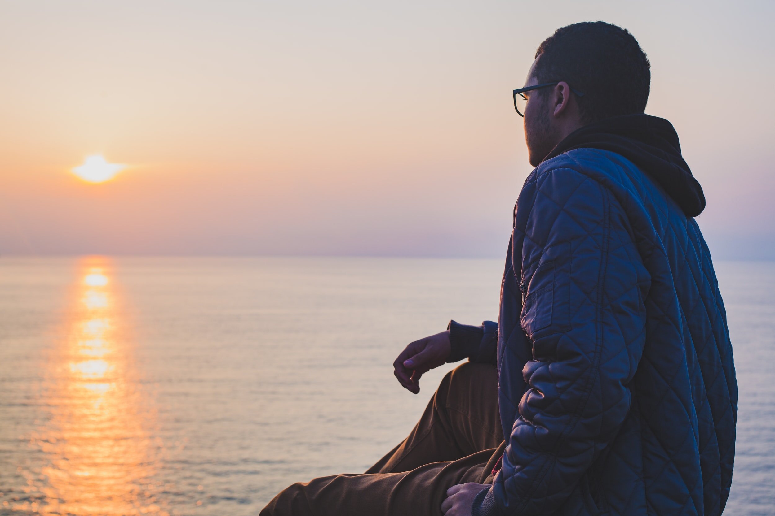 man-looking-out-sunset