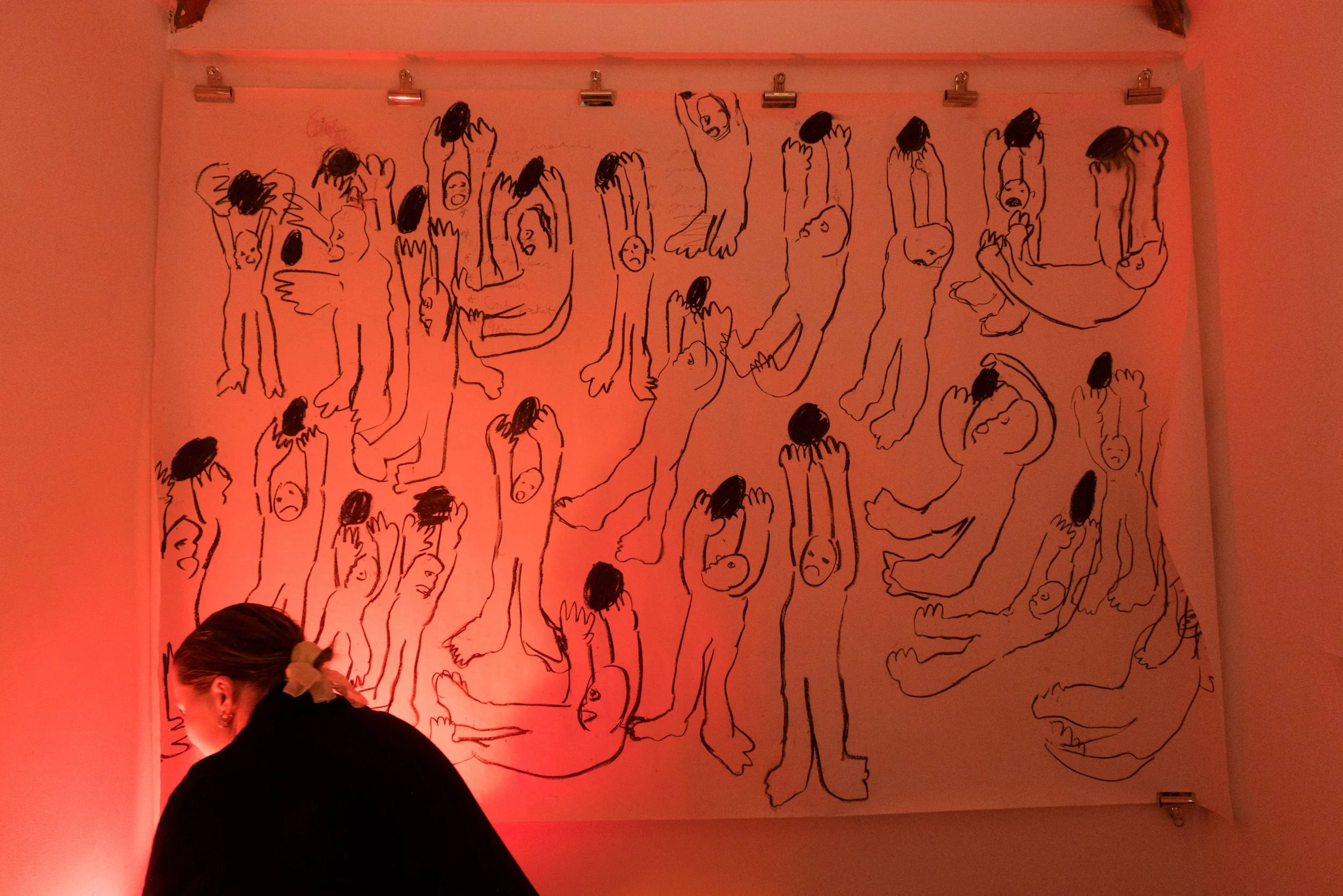 Woman in front of large drawing by artist Katie Houston