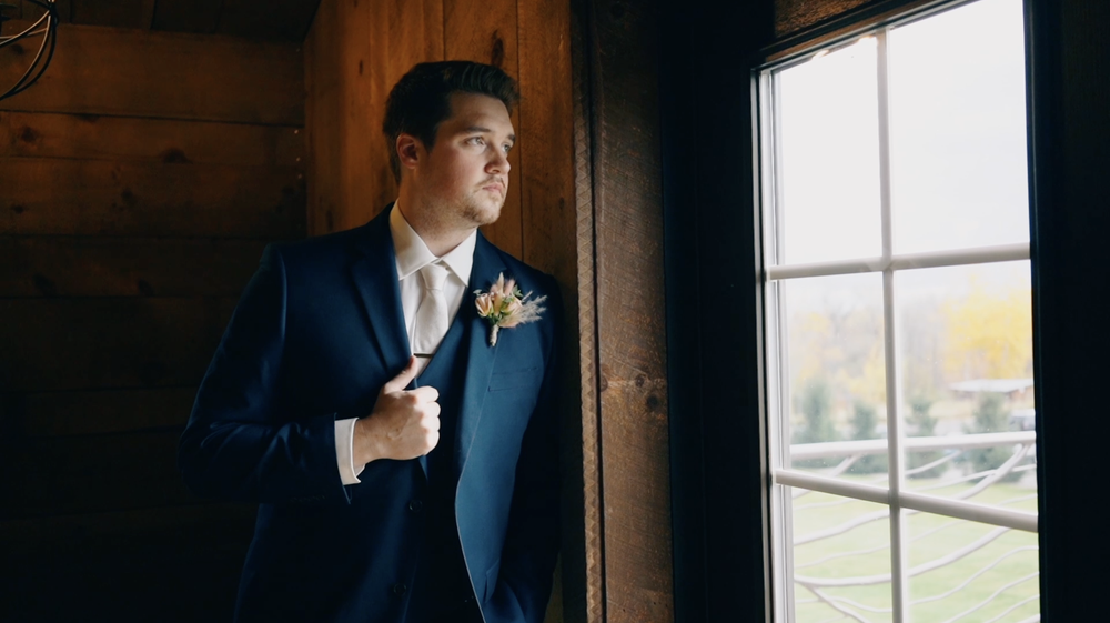 Groom portrait looking out window.png