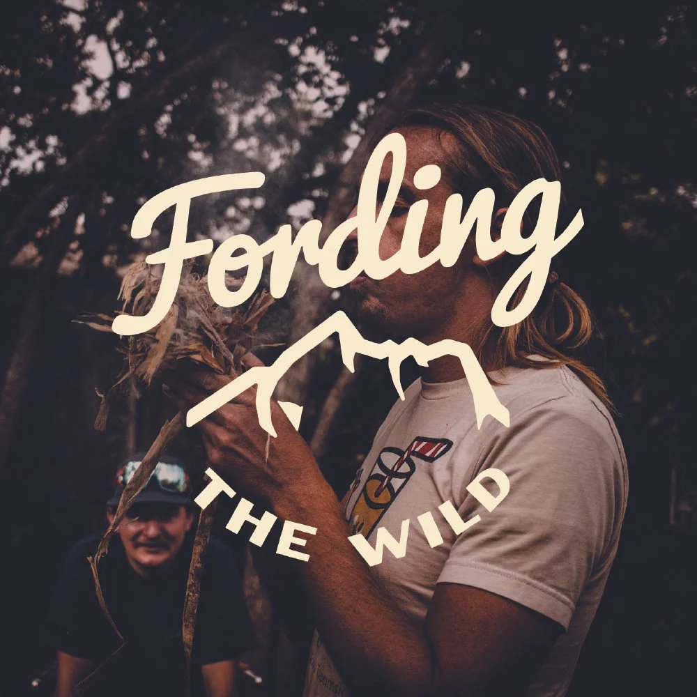 A person holding a dried plant or root, with a logo overlay that says 'Fording the Wild' and a mountain outline. In the background, a man is smiling, all outdoors among trees.