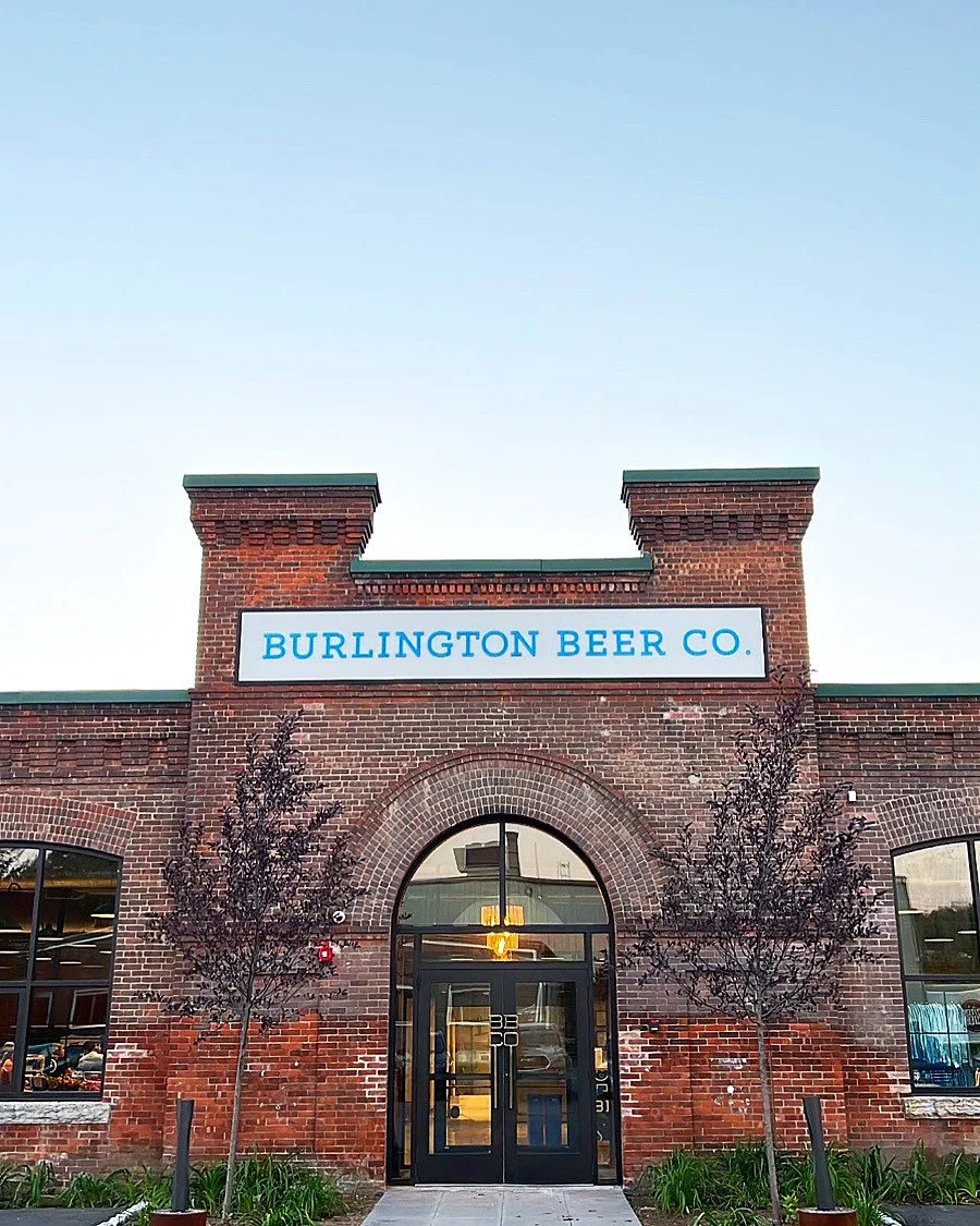 The brick entrance at Flynn Avenue beneath the Burlington Beer Co. sign.