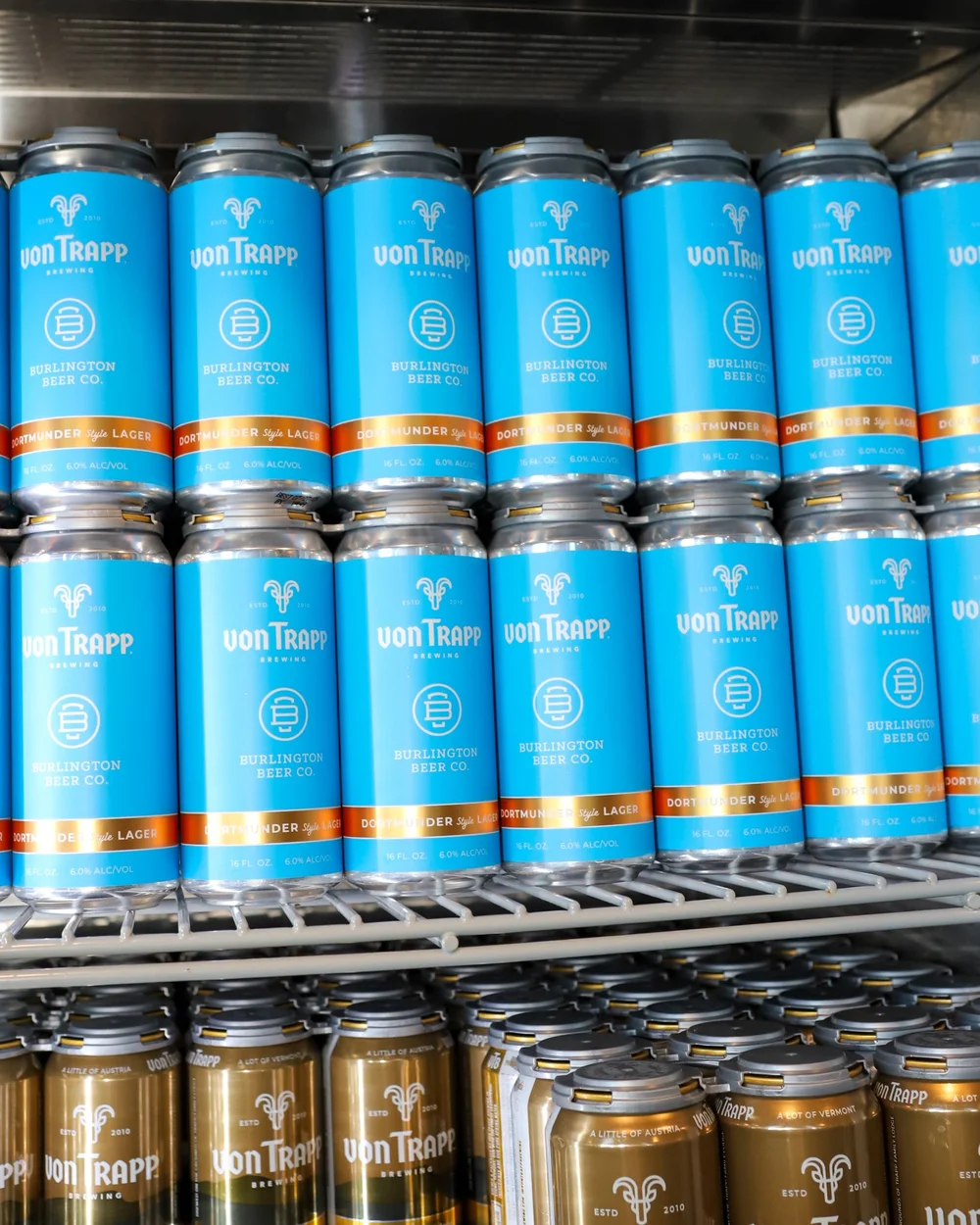 Blue cans of the co-branded von Trapp and Burlington Beer Co. Dortmunder Style Lager.