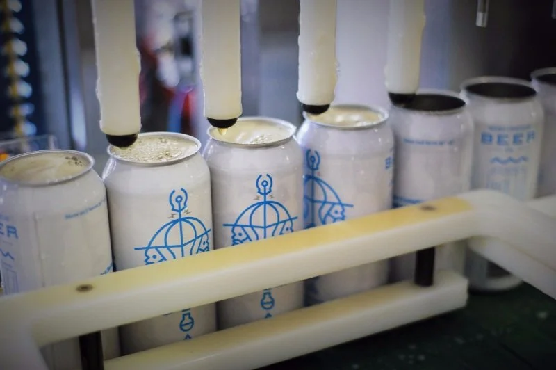 Wizard cans being filled on the early Burlington Beer Co. canning line.