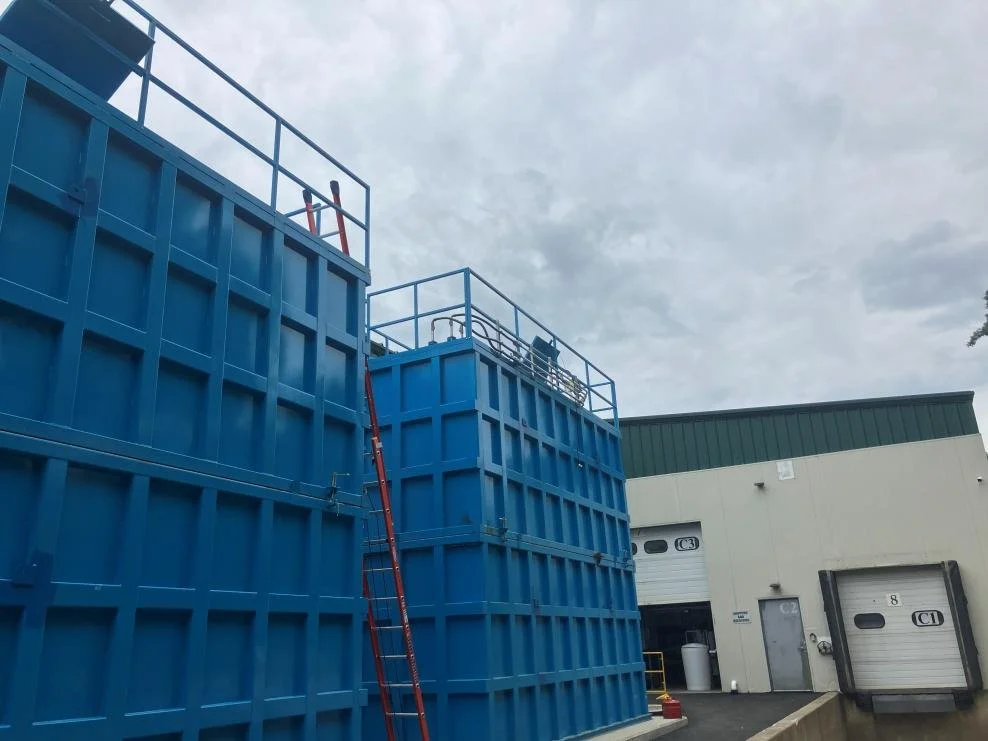 Blue membrane bioreactor tanks installed outside Burlington Beer Co.’s Williston brewery in August 2026.