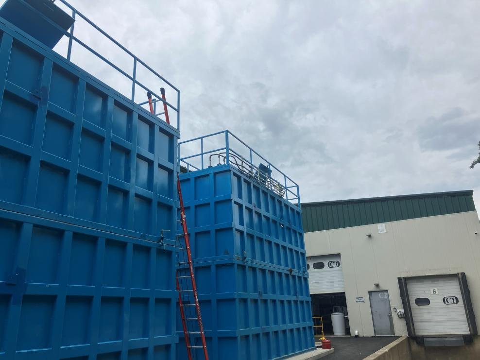 Blue membrane bioreactor tanks installed outside Burlington Beer Co.’s Williston brewery, photographed in August 2026.