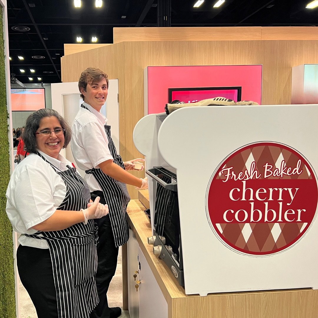 📸🍒 Delicious Moments at the Trade Show 🍒📸
 
Our ambassadors served up mouthwatering cherry cobbler, baked right at our booth. The irresistible aroma drew trade show guests our way. We love serving our guests with a smile!
 
#TradeShowTreats #Cher