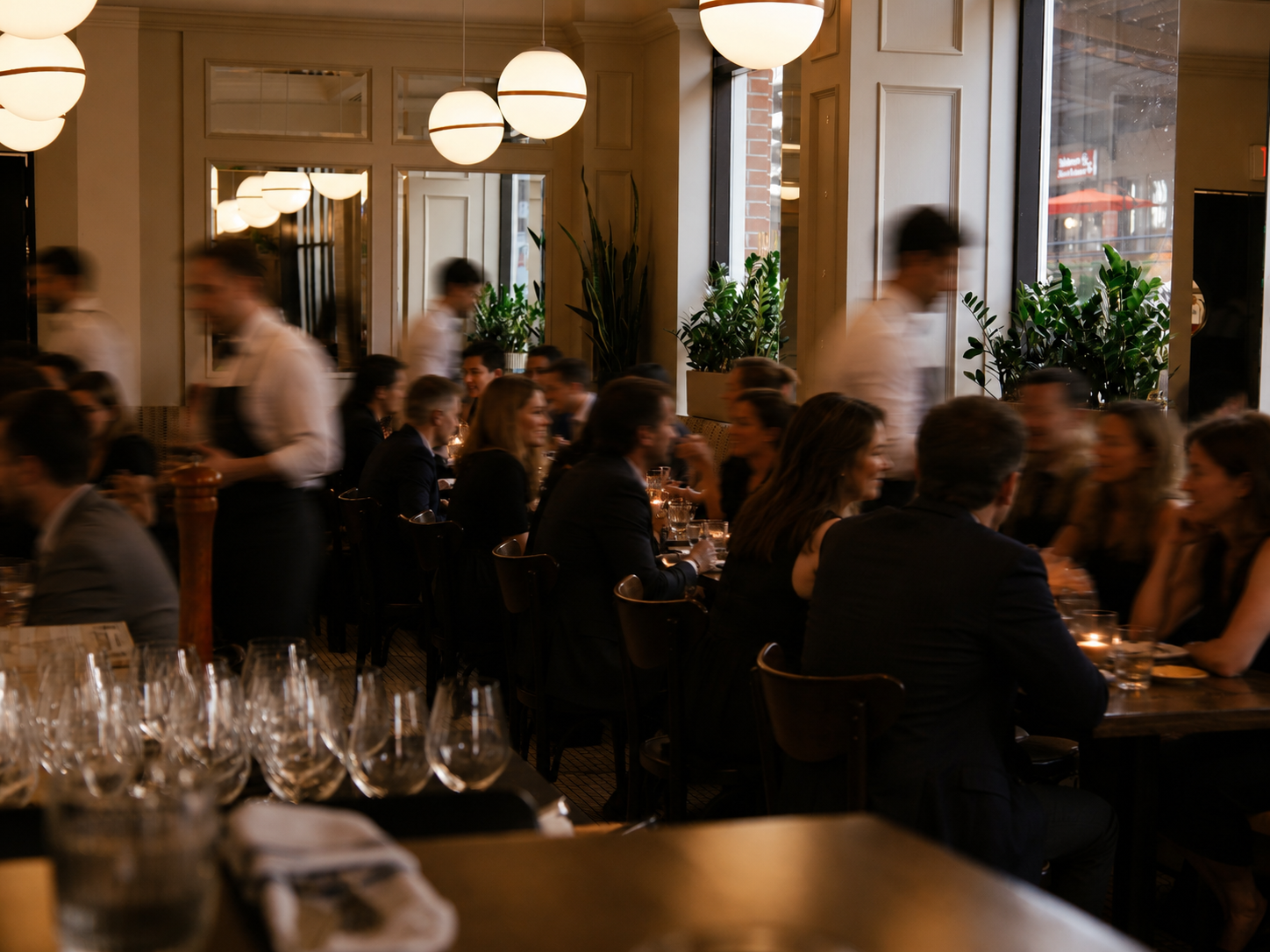 A bustling restaurant scene at Capo and The Spritz in Yaletown specializing in authentic Italian cuisine