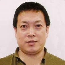 Portrait of a man wearing a collared shirt against a plain background.