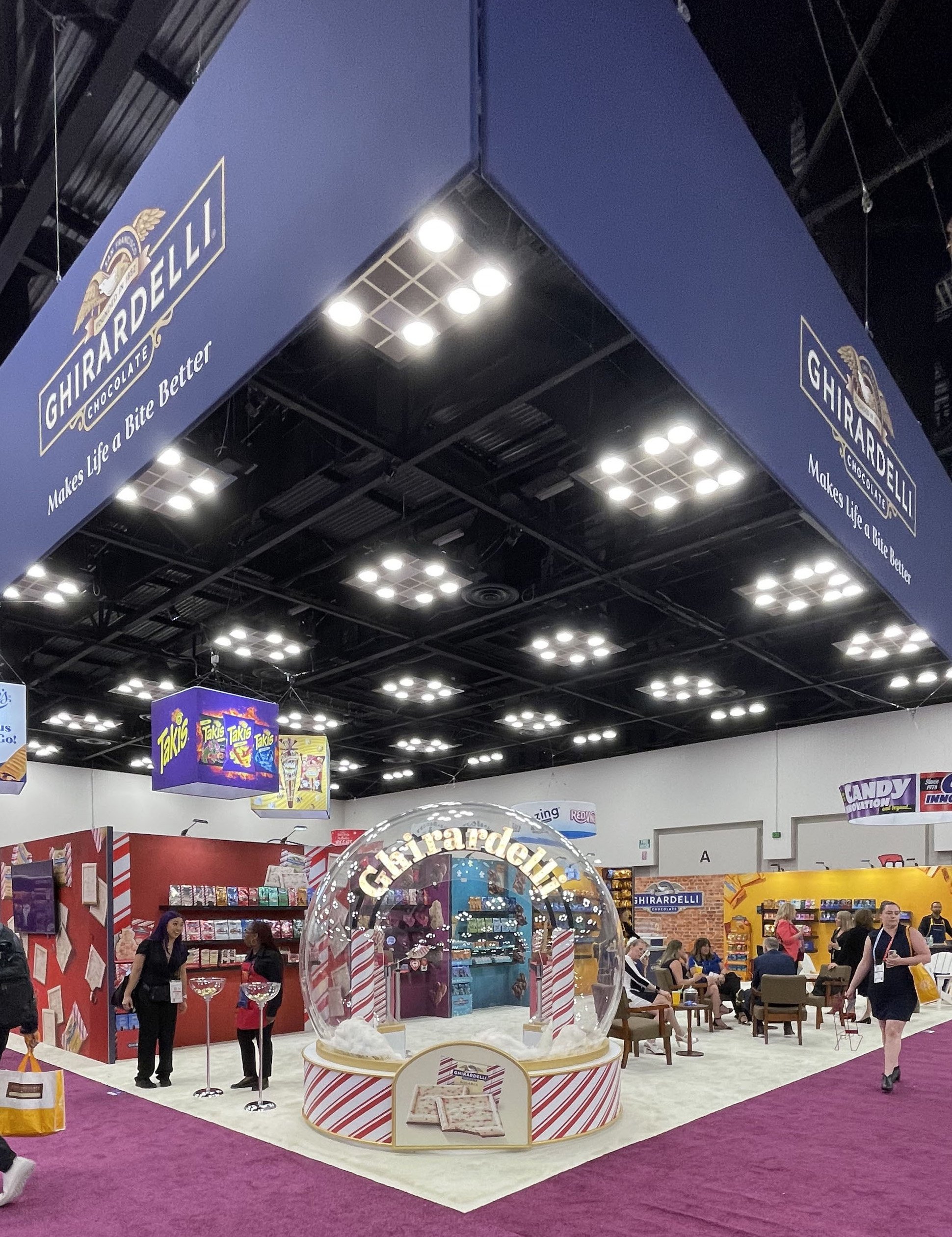 Sweets & Snacks Expo 2024 - Annual tradeshow for the sweets & snacks industry. Multiple areas of interest including an interactive hot cocoa bar and smores creation space, seating areas, meeting rooms and product highlight zones.