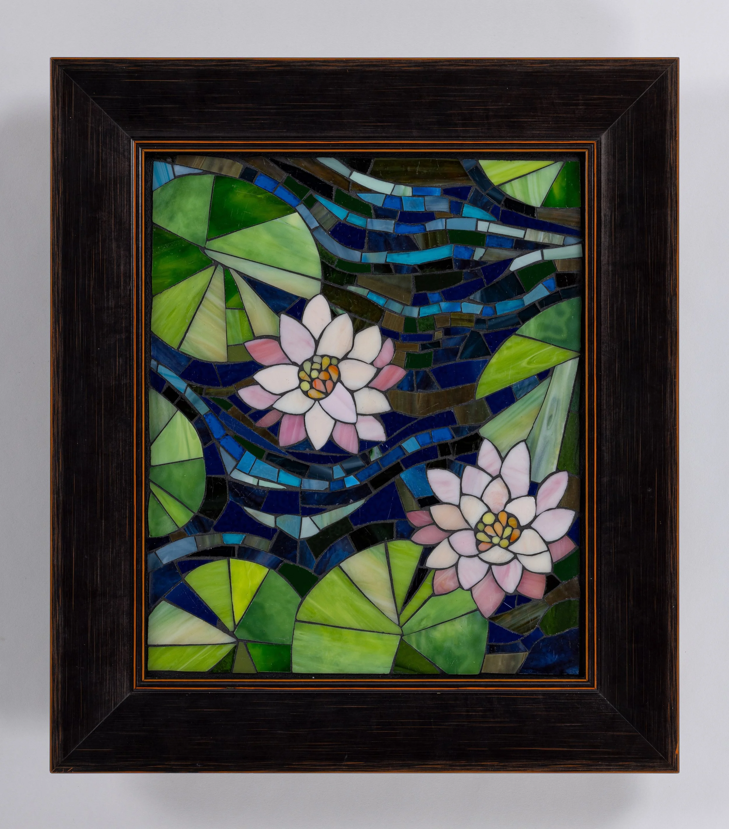 lily pads stained glass mosaic image of pink water lilies with green lily pad leaves in deep blue water with frame