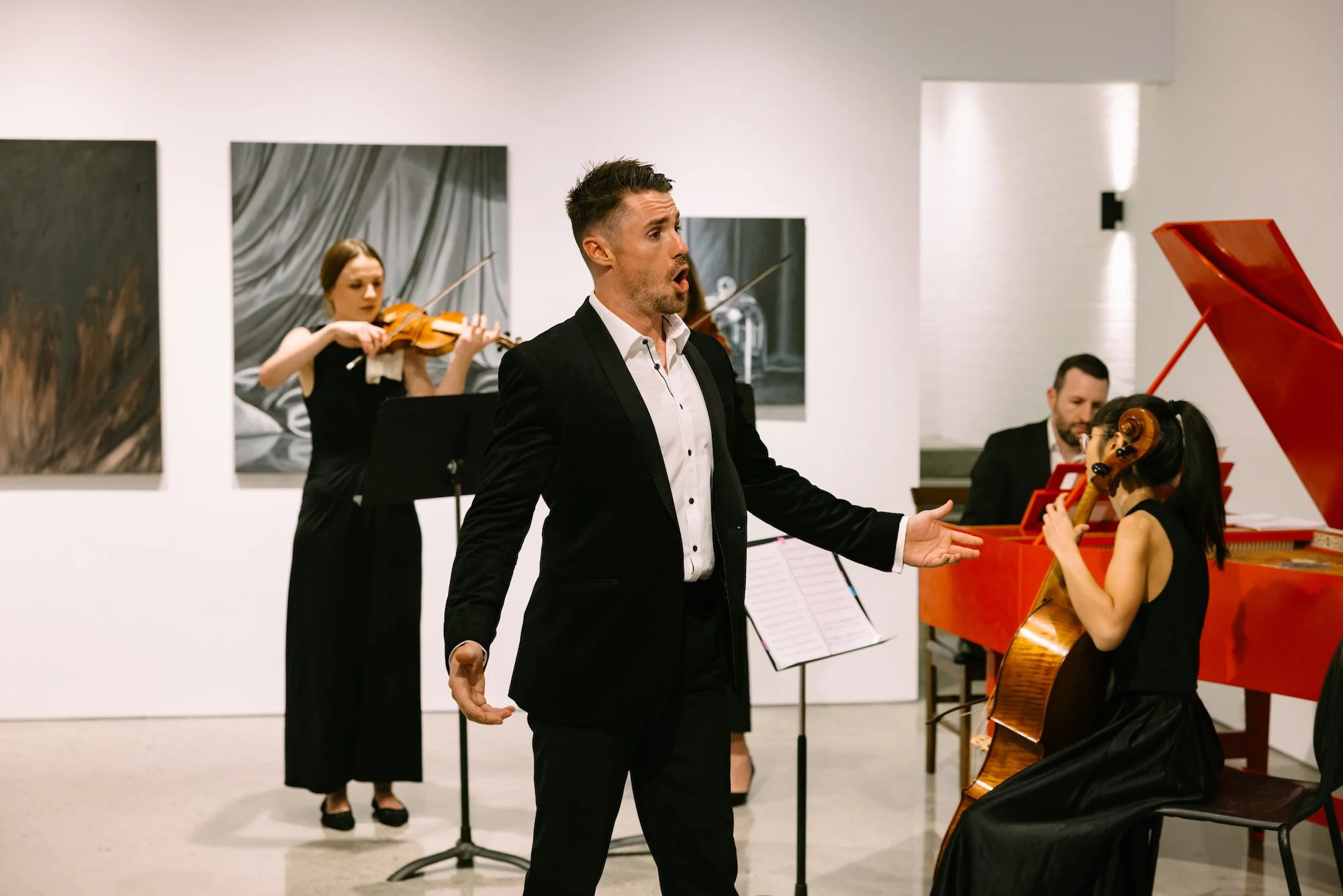 Lachlan Lawton (baritone, playing ‘Jupiter’) with instrumentalists Sarah Papadopoulos, James Huntingford and Krista Low, in John Eccles’ opera ‘Semele’, April 2024. Preview performance at exhibition opening by Moira de la Hunty at Stala Contemporary.