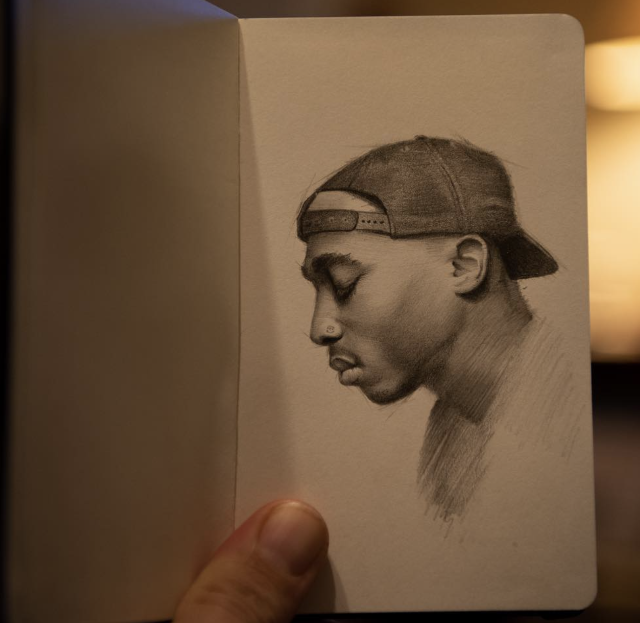 Charcoal, white chalk, pan pastel realism drawing of Tupac. Brian Parrillo art, fine art, tattoo artist in Durham North Carolina at Ethereal Tattoo Gallery. On display in Durham, North Carolina.