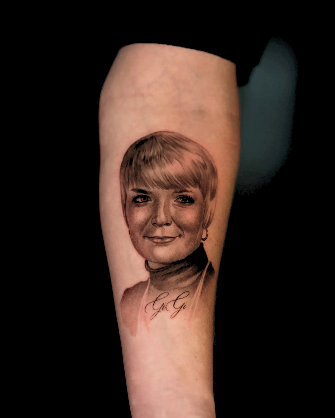 Black and grey realism memorial portrait tattoo with script lettering "Gi Gi" on forearm by Durham tattoo artist Brian Parrillo at Ethereal Tattoo Gallery