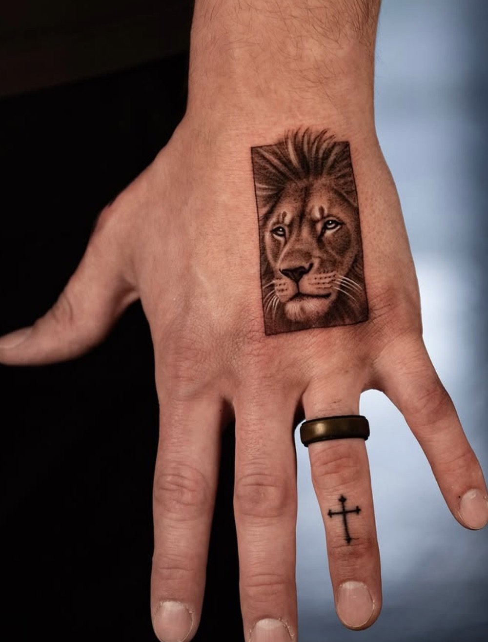 Single needle microrealism lion portrait tattoo on the back of a hand by Brian Parrillo Durham NC