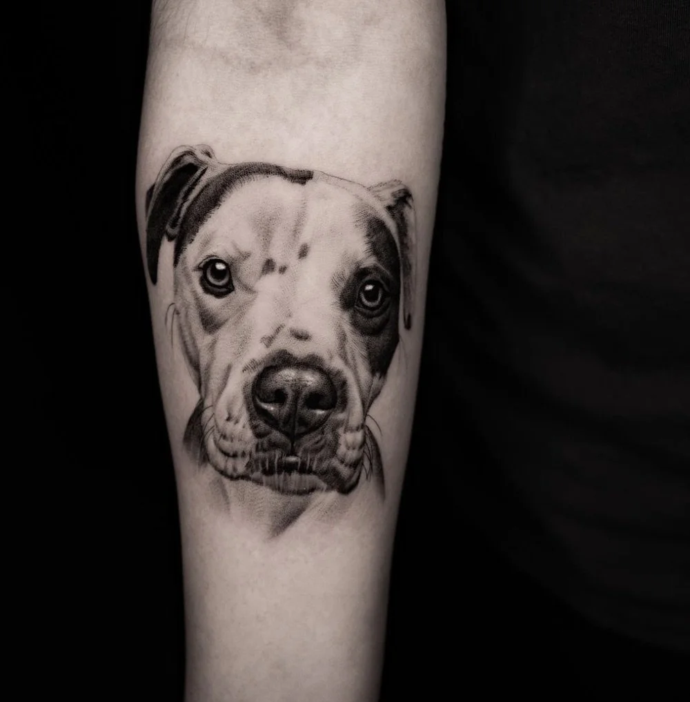 Black and grey realism tattoo of a dog by Brian Parrillo Durham NC