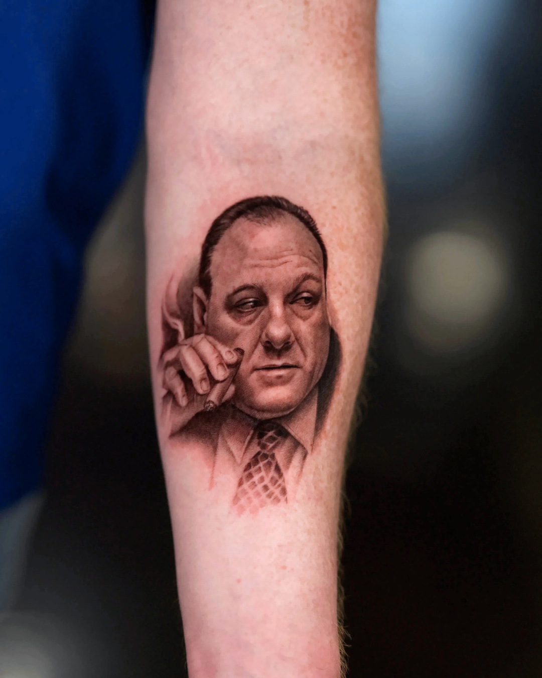 Hyper-realistic black and grey Tony Soprano forearm celebrity portrait tattoo depicting character holding a cigarette, by realism tattoo artist Brian Parrillo in Durham NC