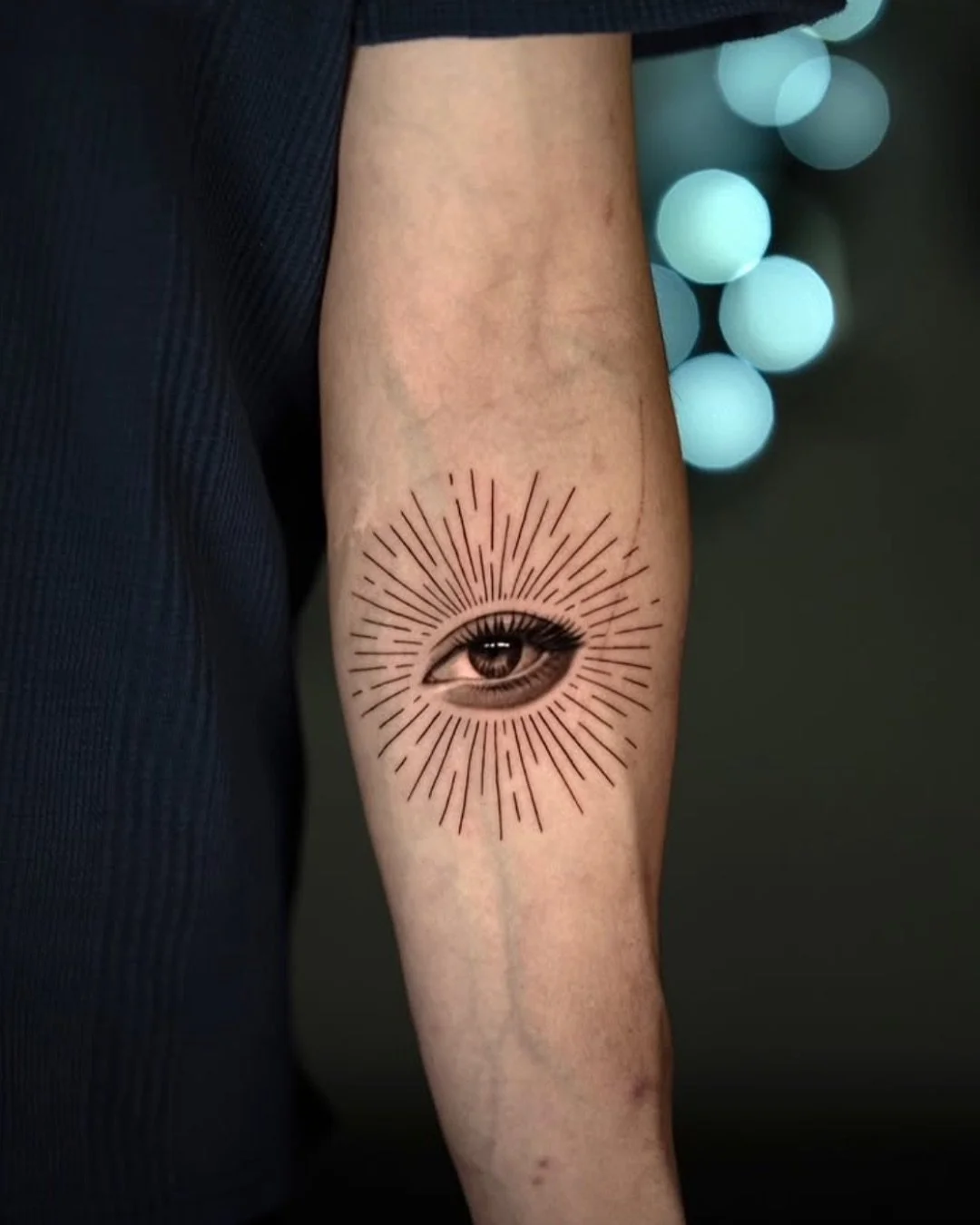 Large black realism eye tattoo with teardrop detail on inner arm by Brian Parrillo Durham NC