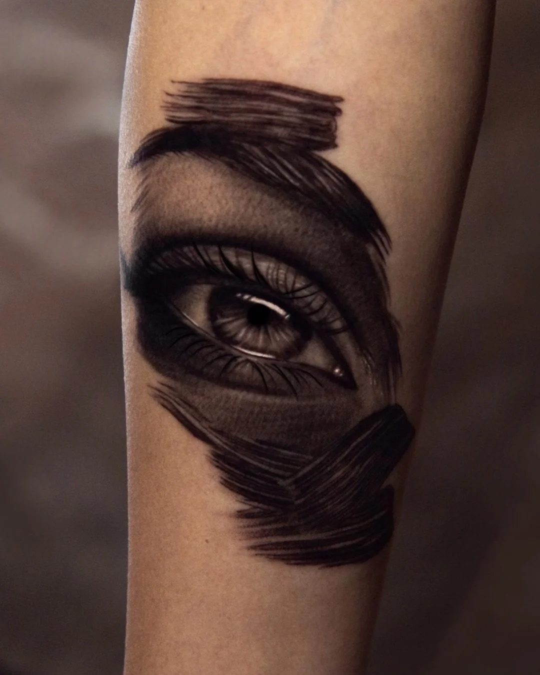 Realistic black and grey eye tattoo with bold brushstroke texture on forearm by Brian Parrillo Durham NC