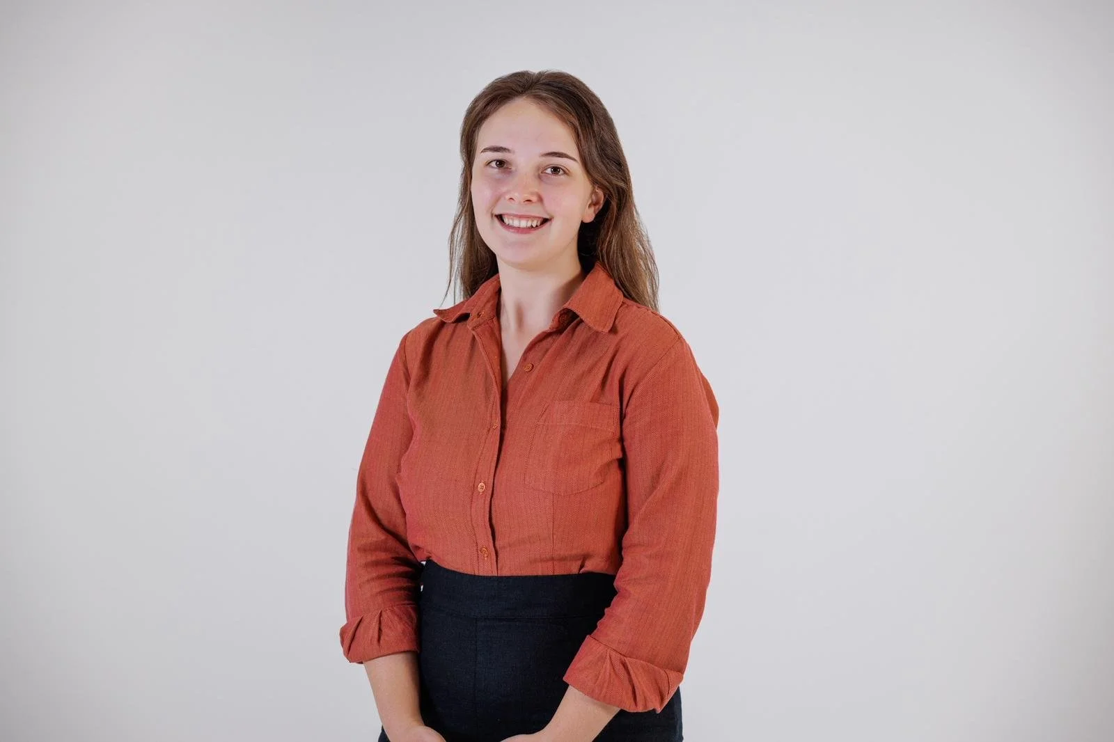 Smiling woman with red shirt and white background
