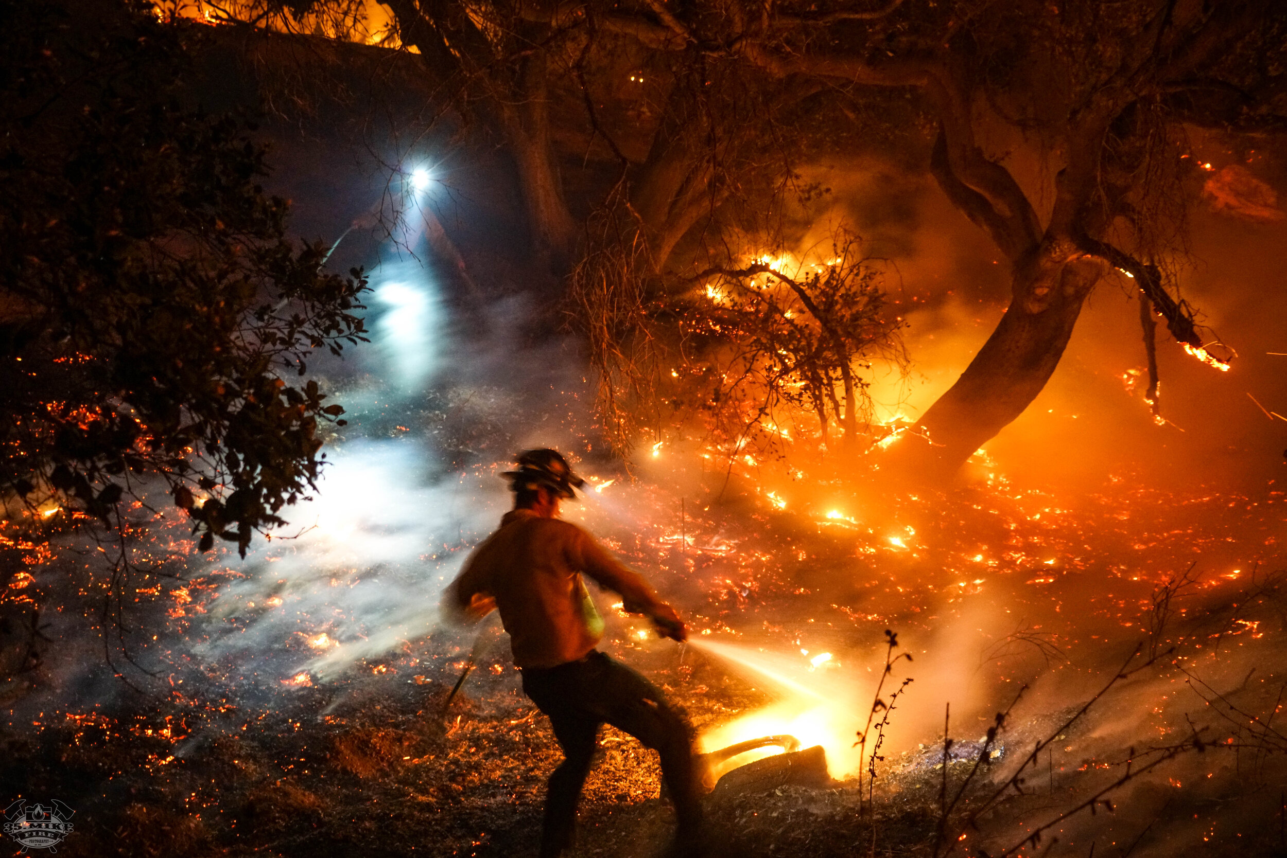 Casey and Kevin Extinguishing embers in the backyard of 6129 Fairview place in Agoura hills.