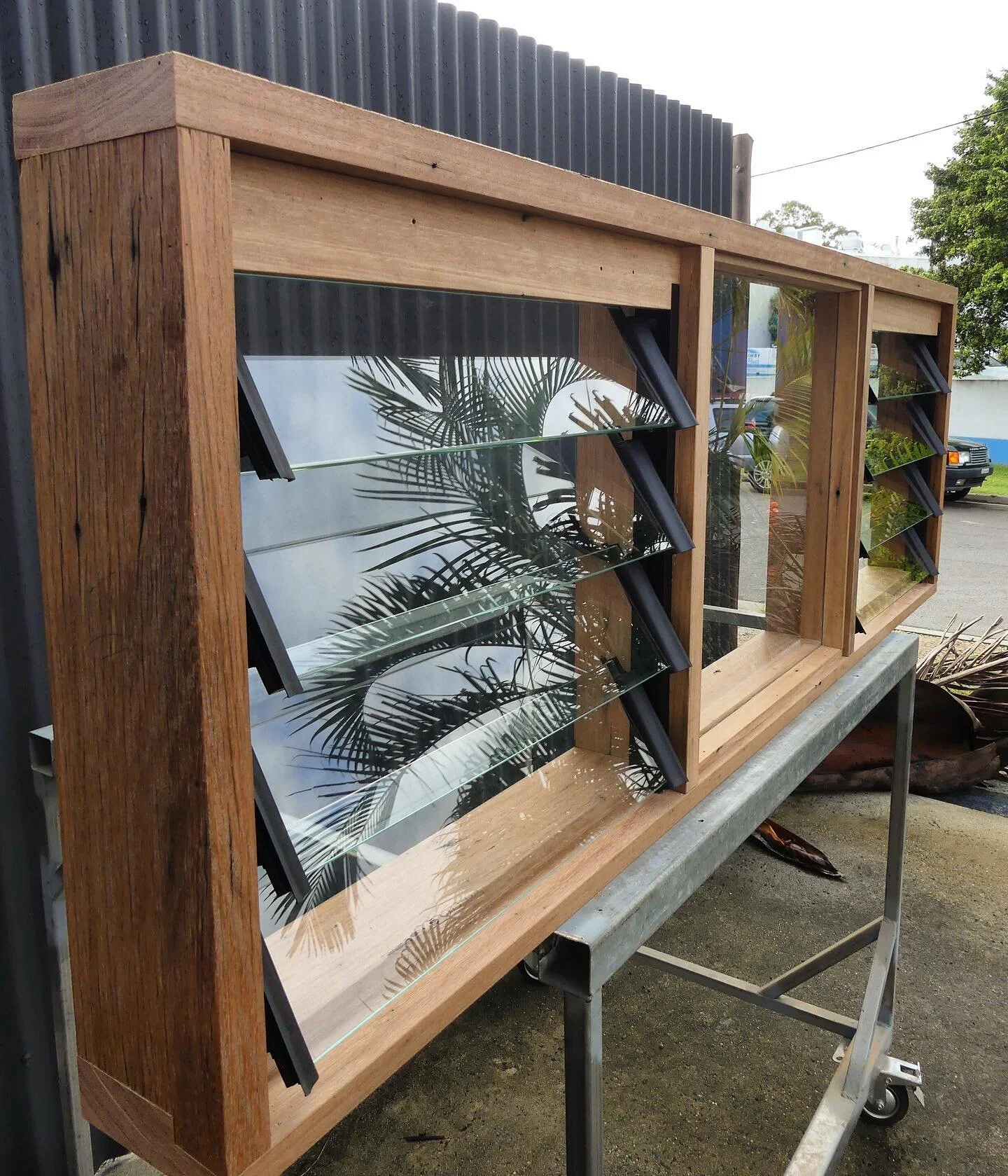 Custom louvred windows in recycled hardwood, ready for installation 🔨