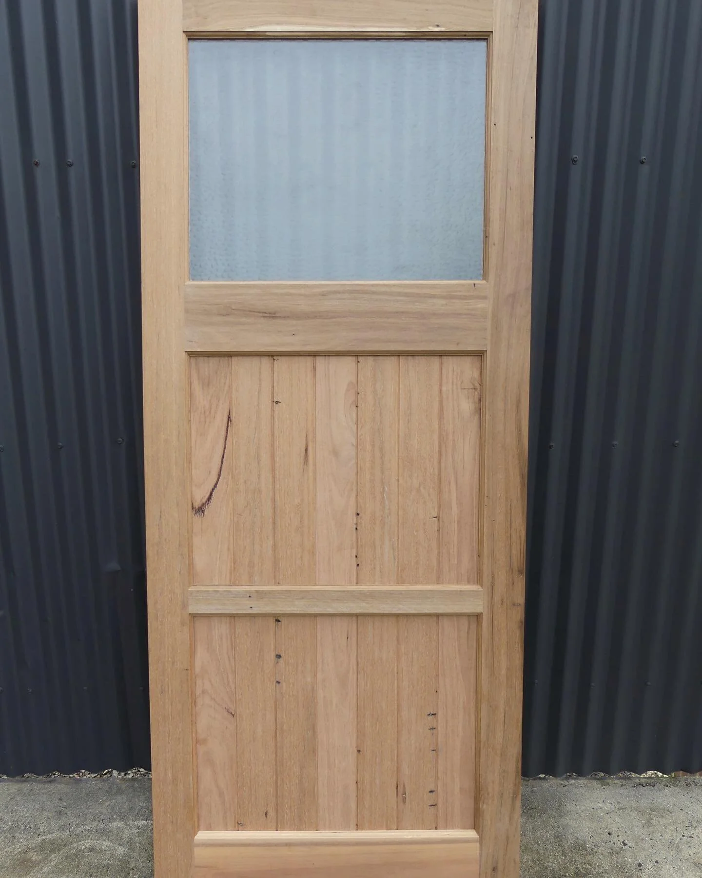 Custom built recycled hardwood door ready to be installed.