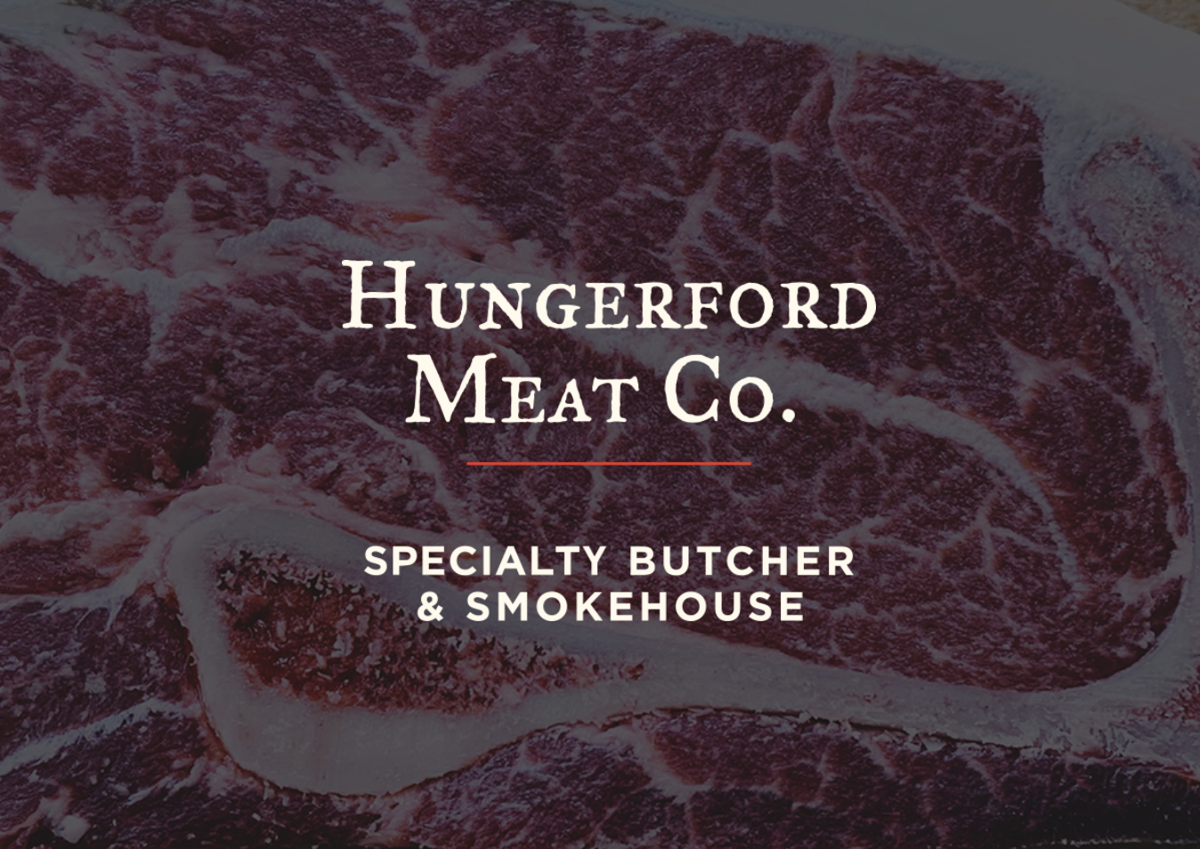 Close-up of raw, marbled steak with overlay text for Hungerford Meat Co., a specialty butcher and smokehouse.